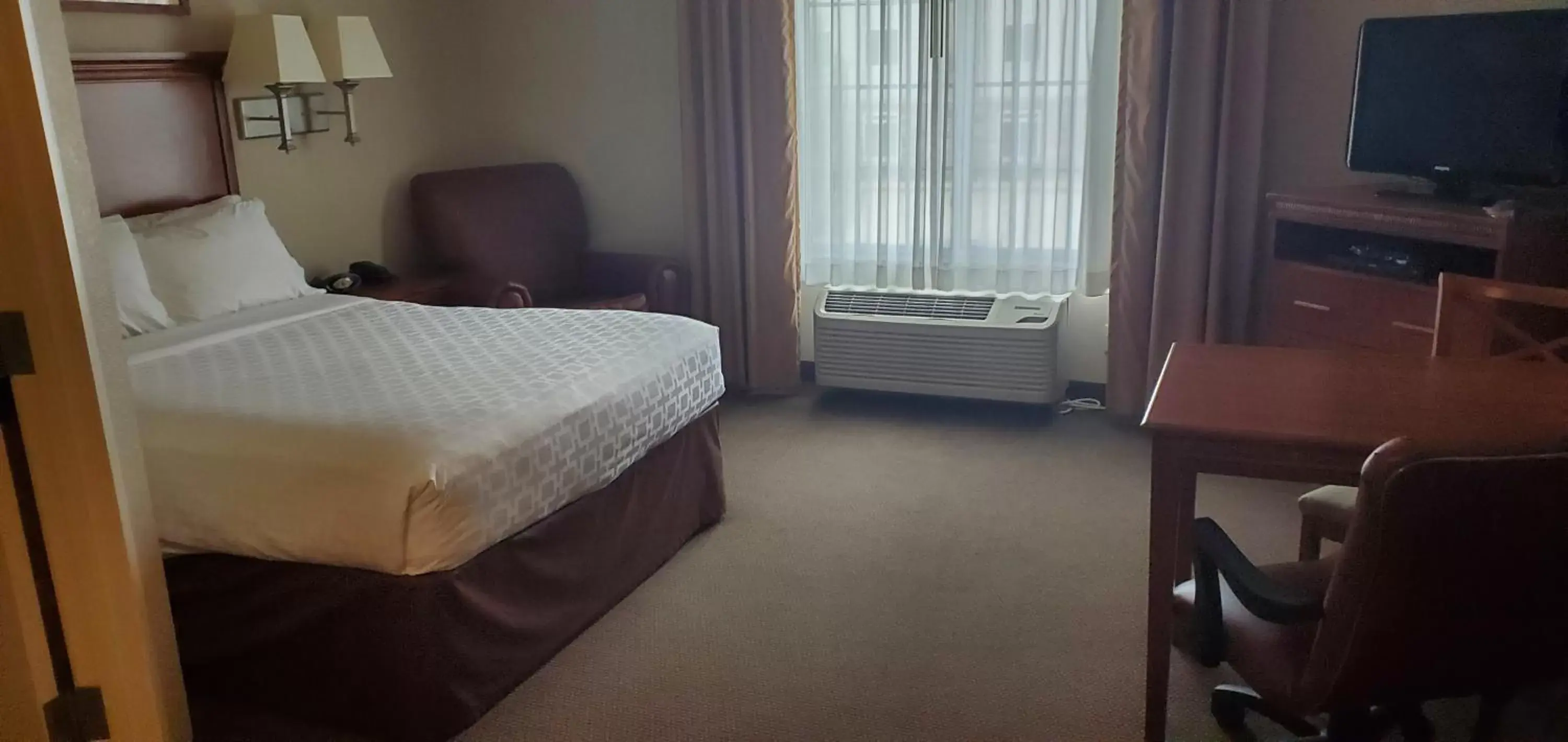 Bed in Candlewood Suites Champaign-Urbana University Area, an IHG Hotel