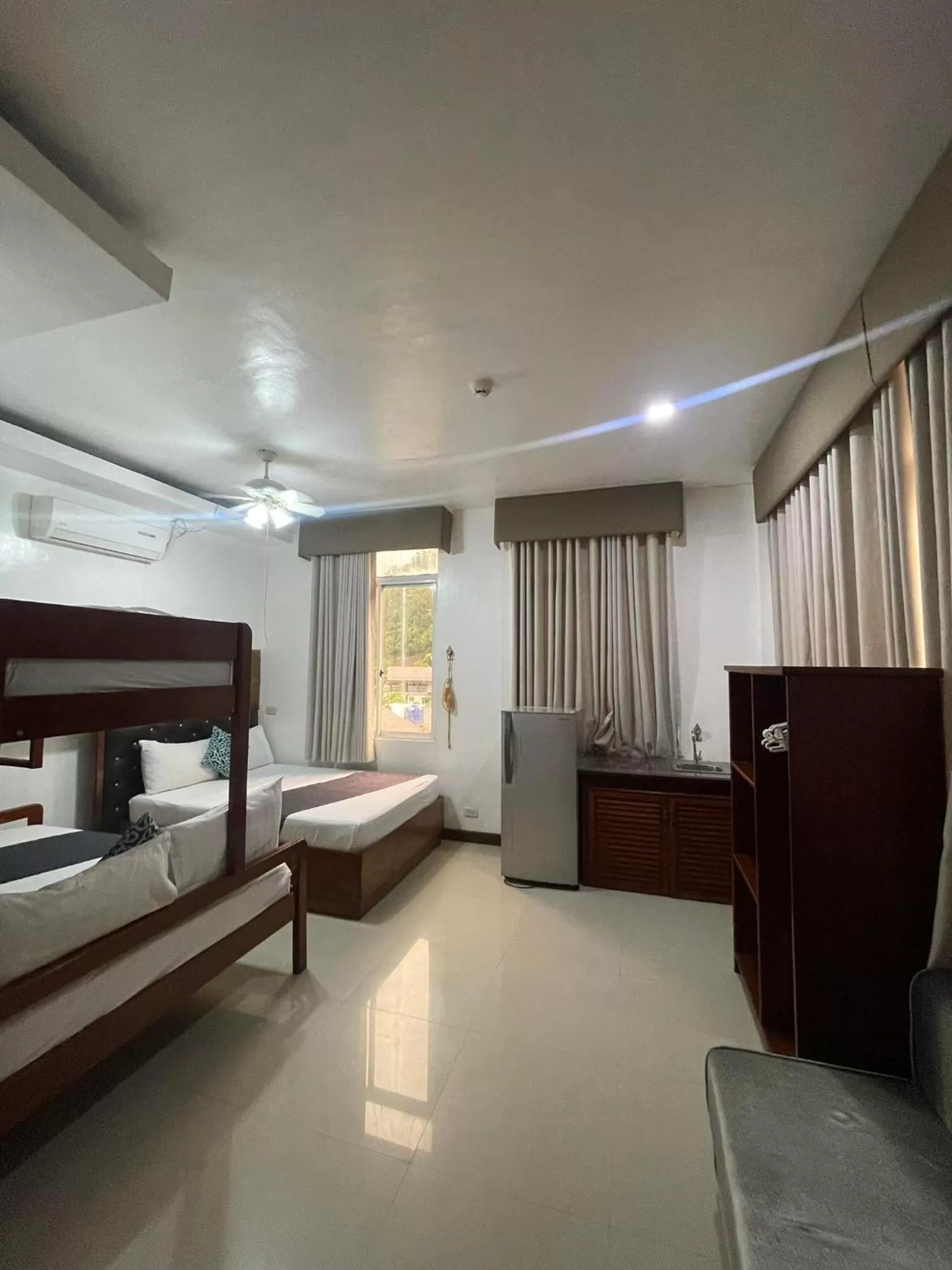 Bed in El Nido Royal Palm Inn