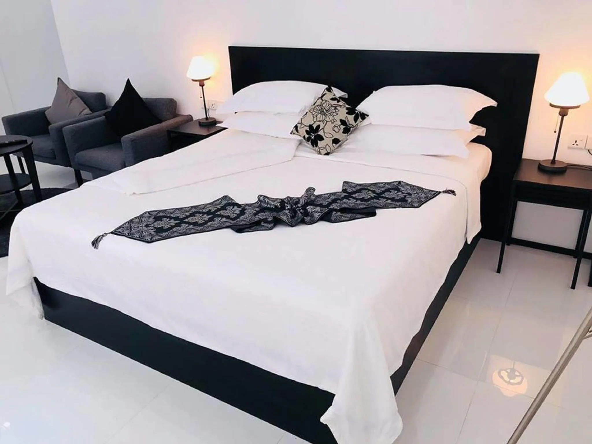 Bed in YAMA HOTEL & ROOFTOP BAR