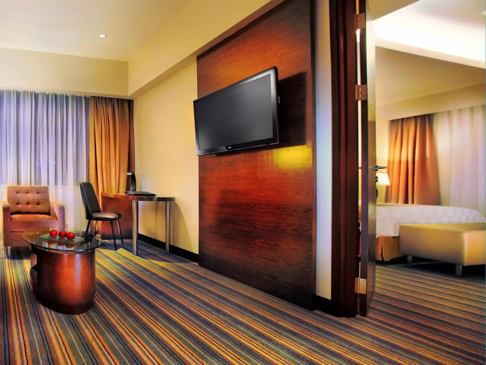 Photo of the whole room, TV/Entertainment Center in ASTON Makassar Hotel & Convention Center