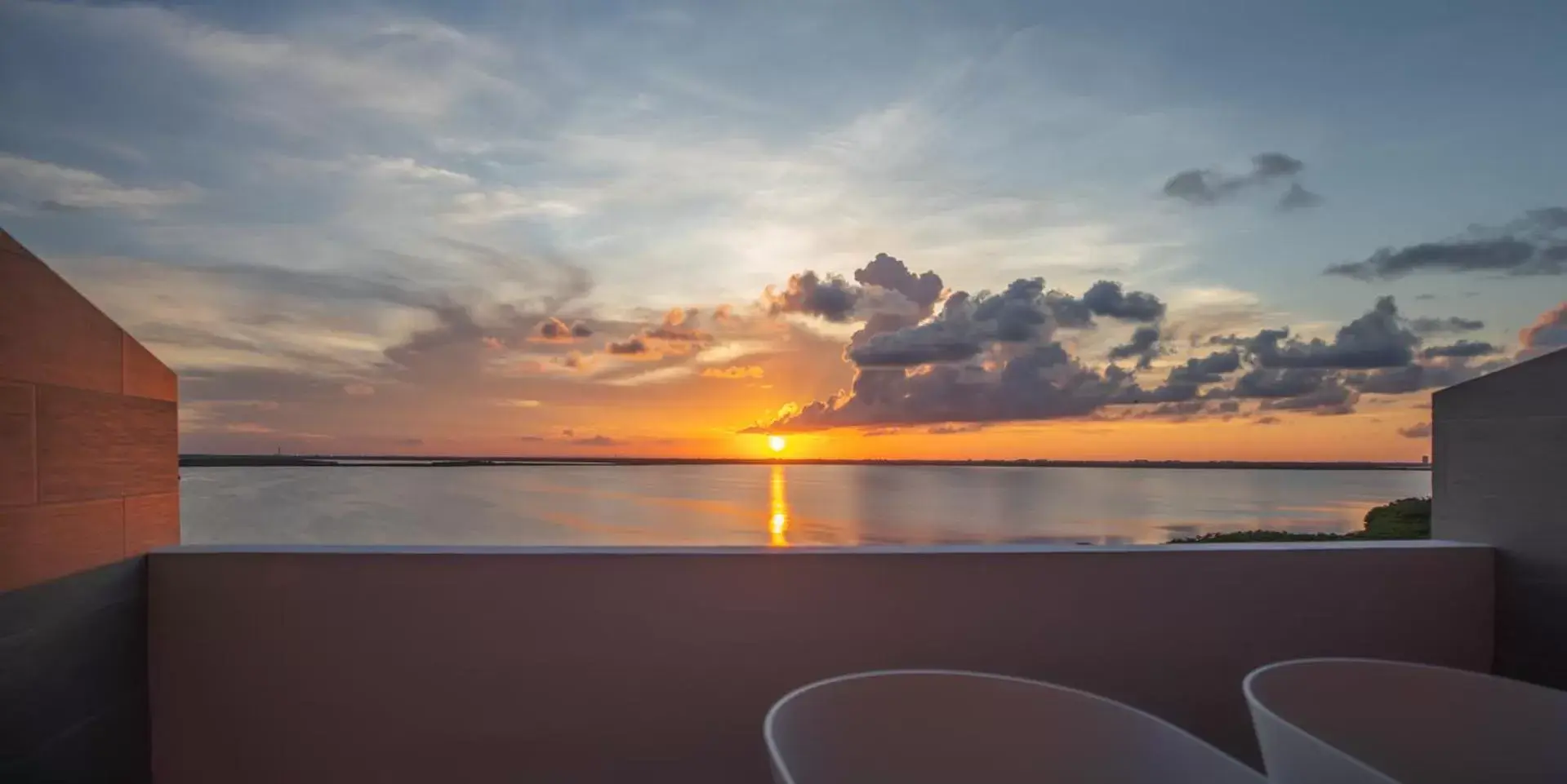 Sunset in Beachfront Penthouses by LivIN Cancun