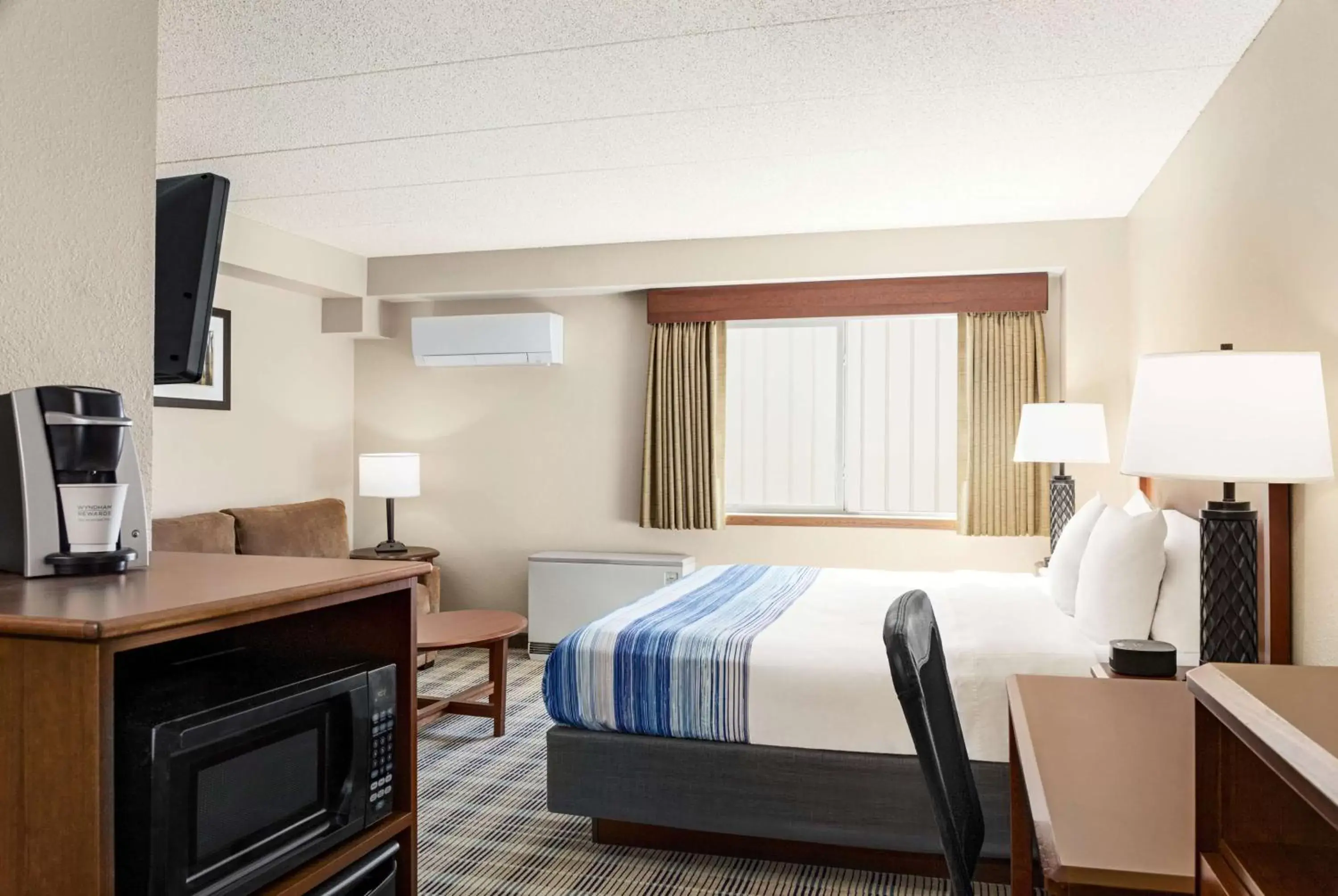 Bed in AmericInn by Wyndham Roseau