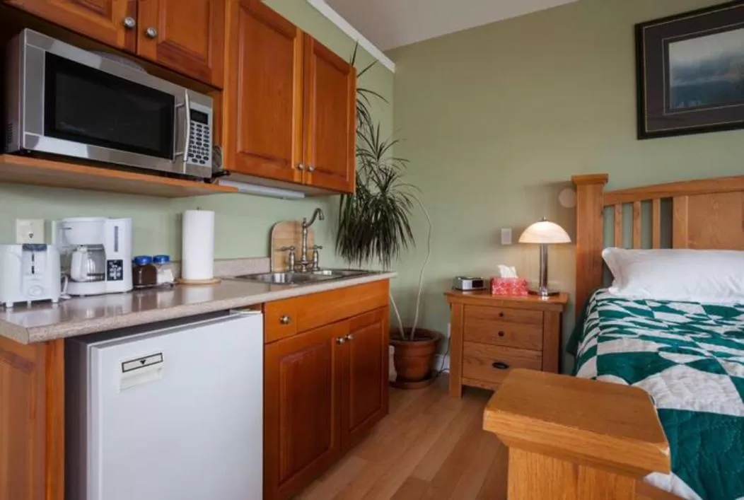 Bed in Birds of a Feather Victoria Oceanfront Studio Suites