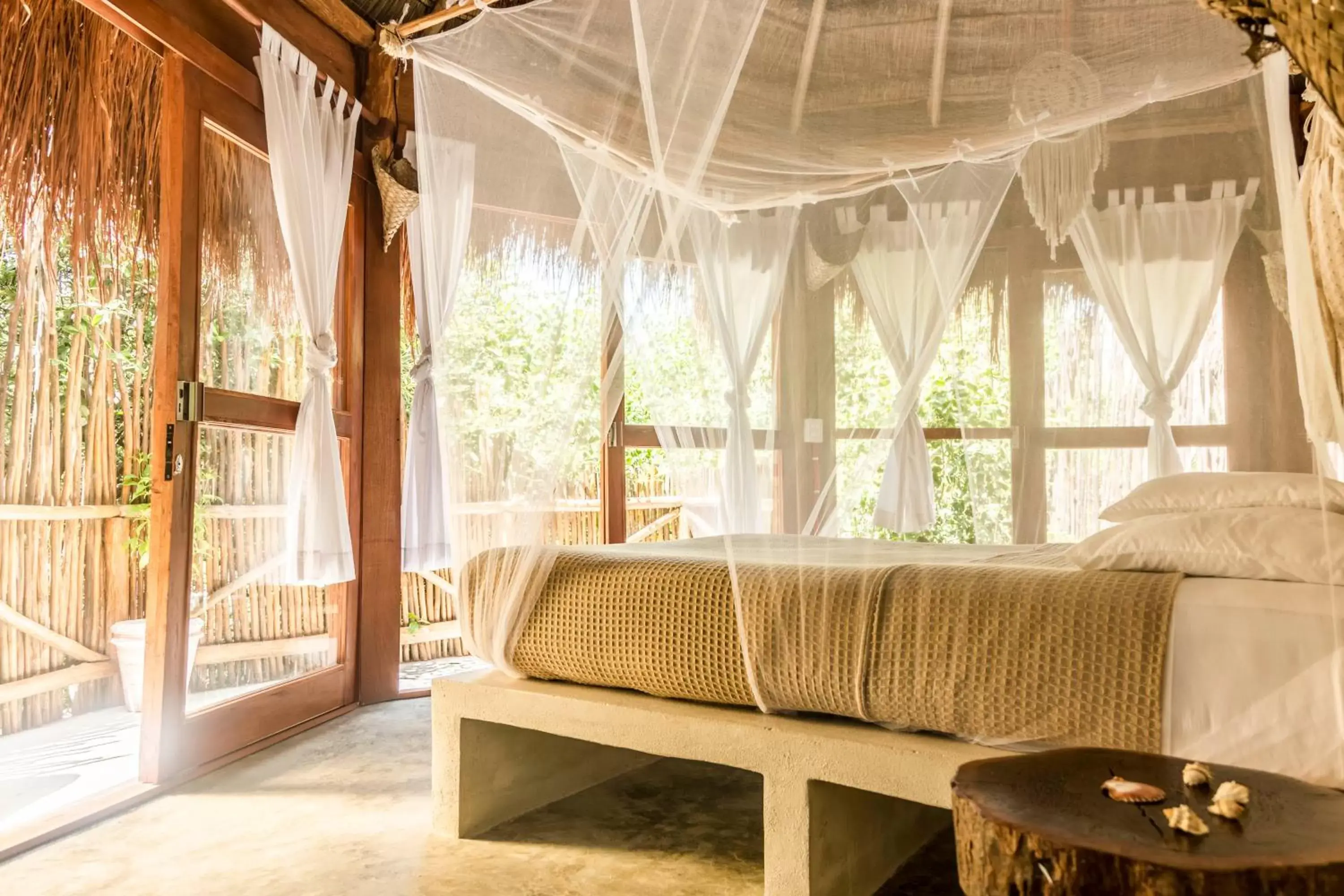 Bed, Seating Area in Mamasan Treehouses & Cabins