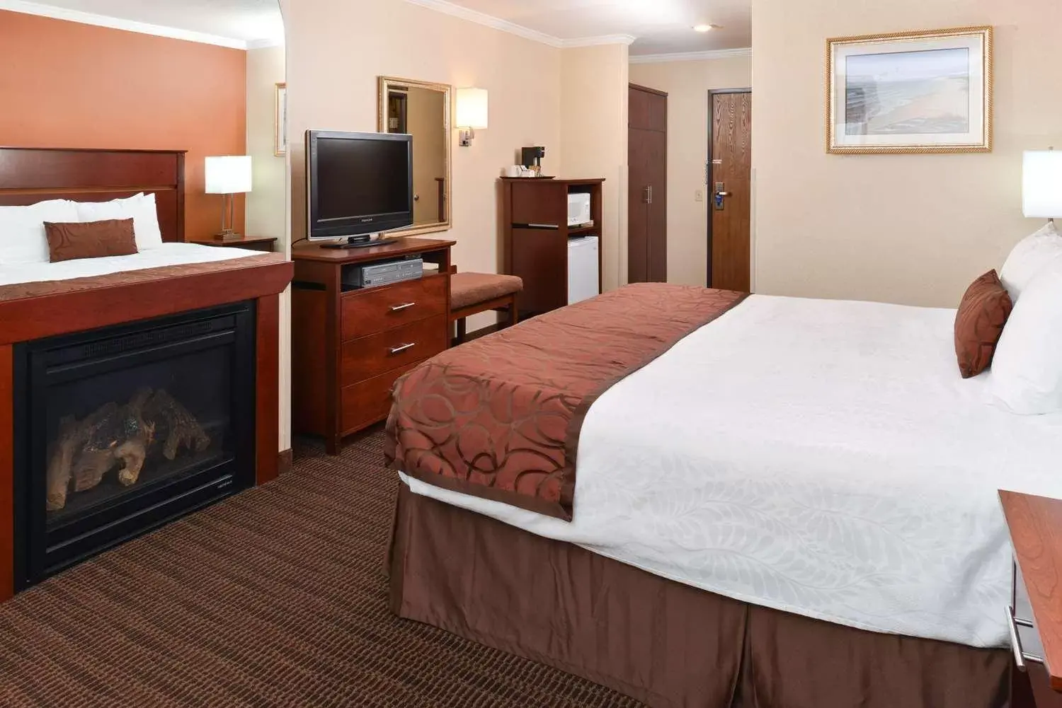 king room with fireplace and balcony in Best Western Plus Landmark Inn