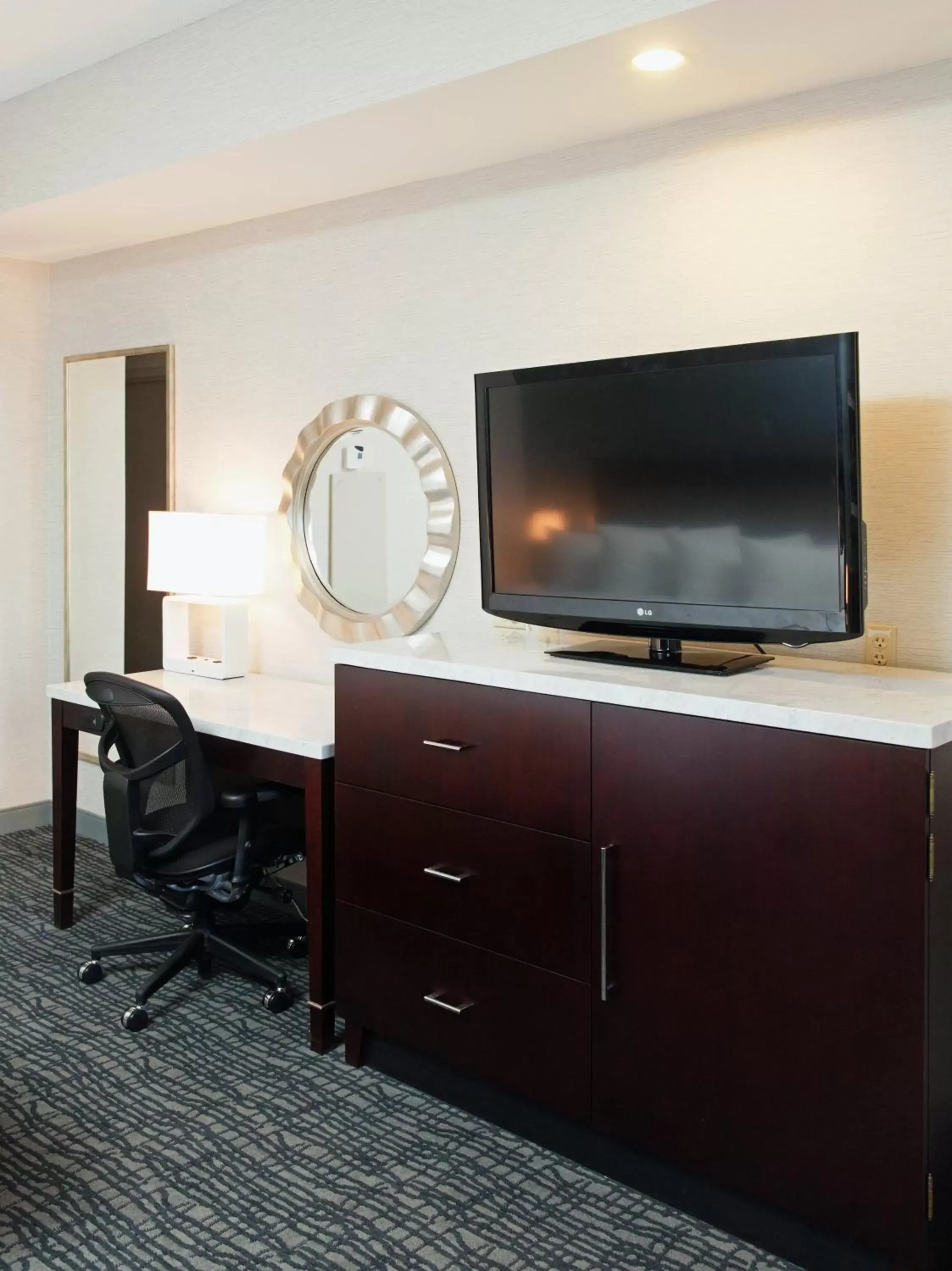 Photo of the whole room, TV/Entertainment Center in Crowne Plaza Springfield Convention Center, an IHG Hotel