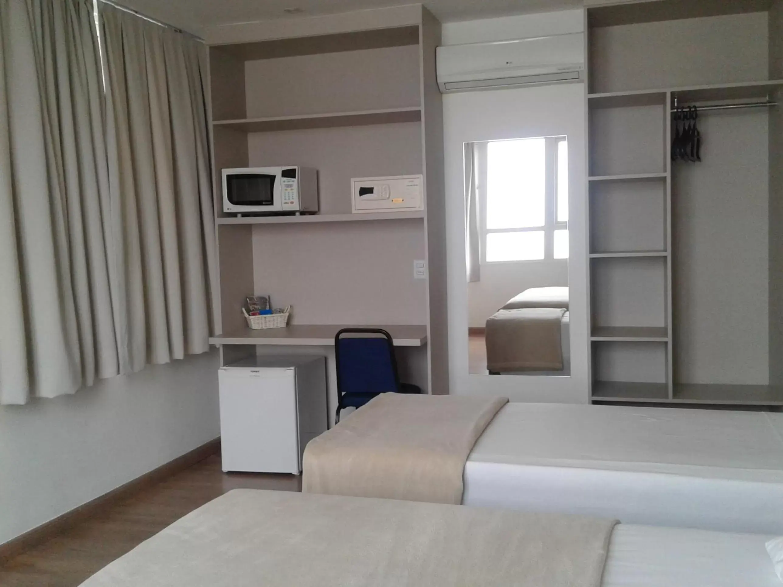 Photo of the whole room, TV/Entertainment Center in Coral Hotel - Próximo Av Carlos Gomes, PUCRS