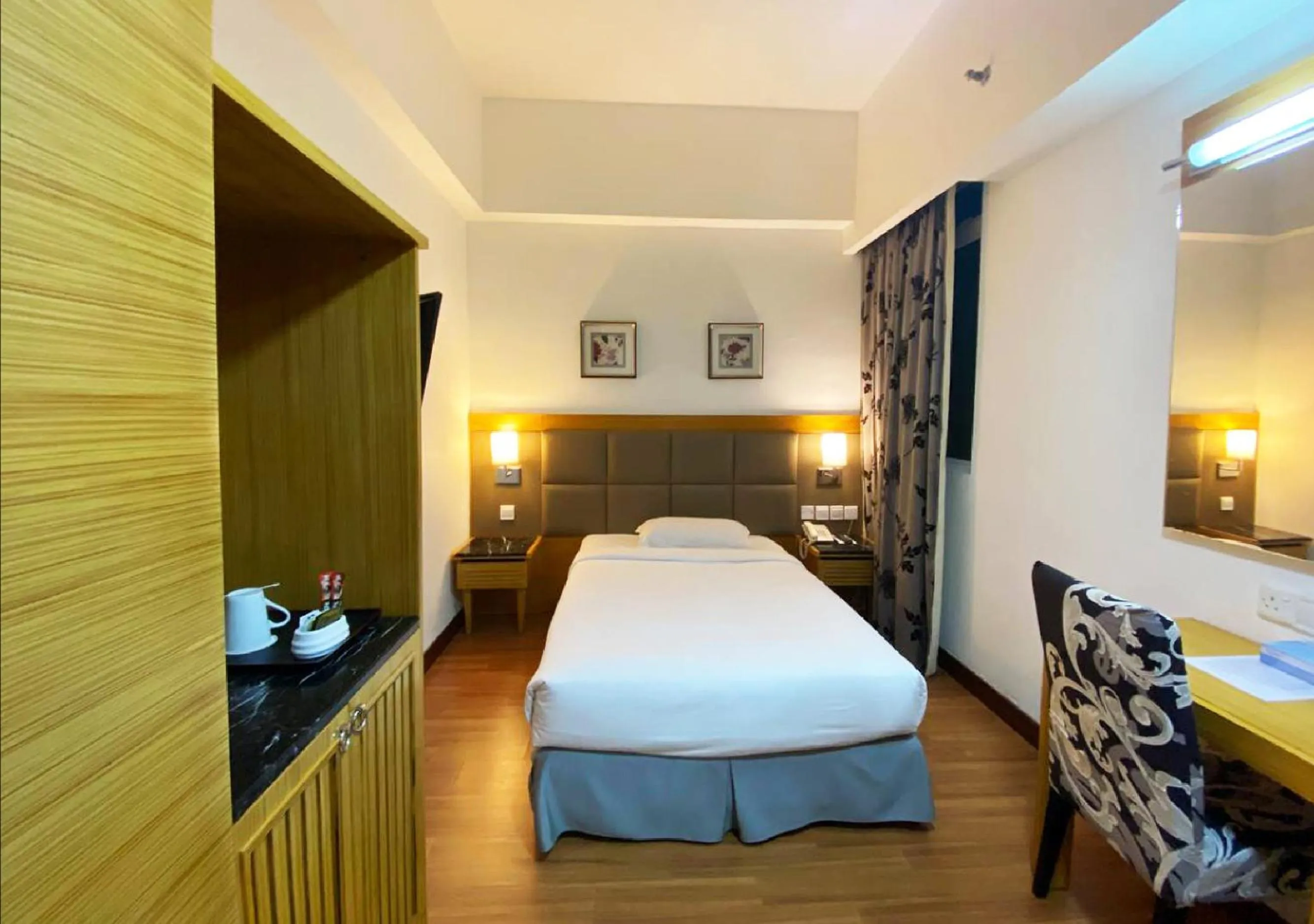 Bed in Crown Garden Hotel