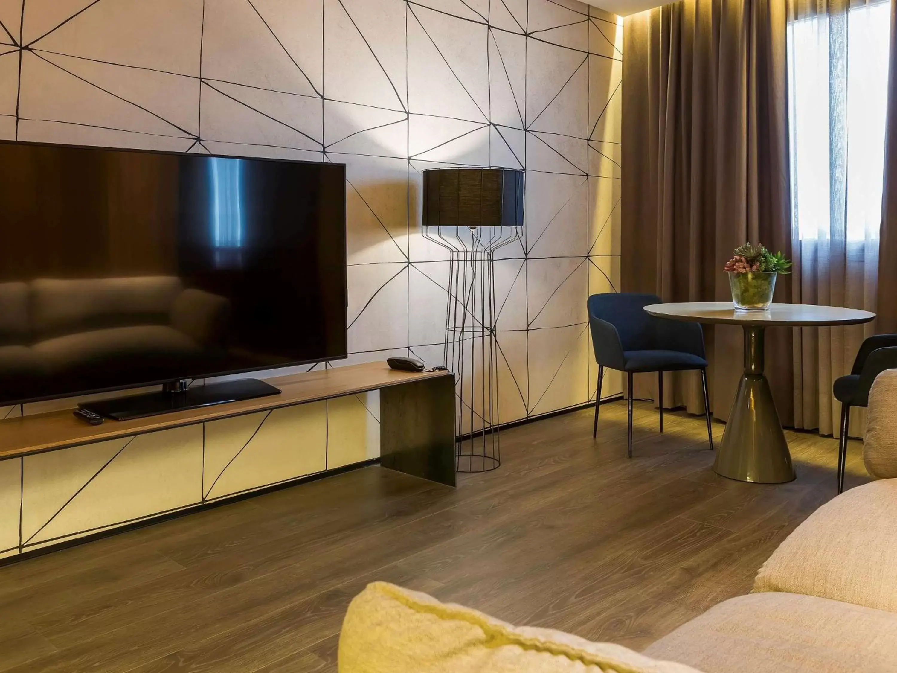 Photo of the whole room, TV/Entertainment Center in Hotel Novotel Sevilla