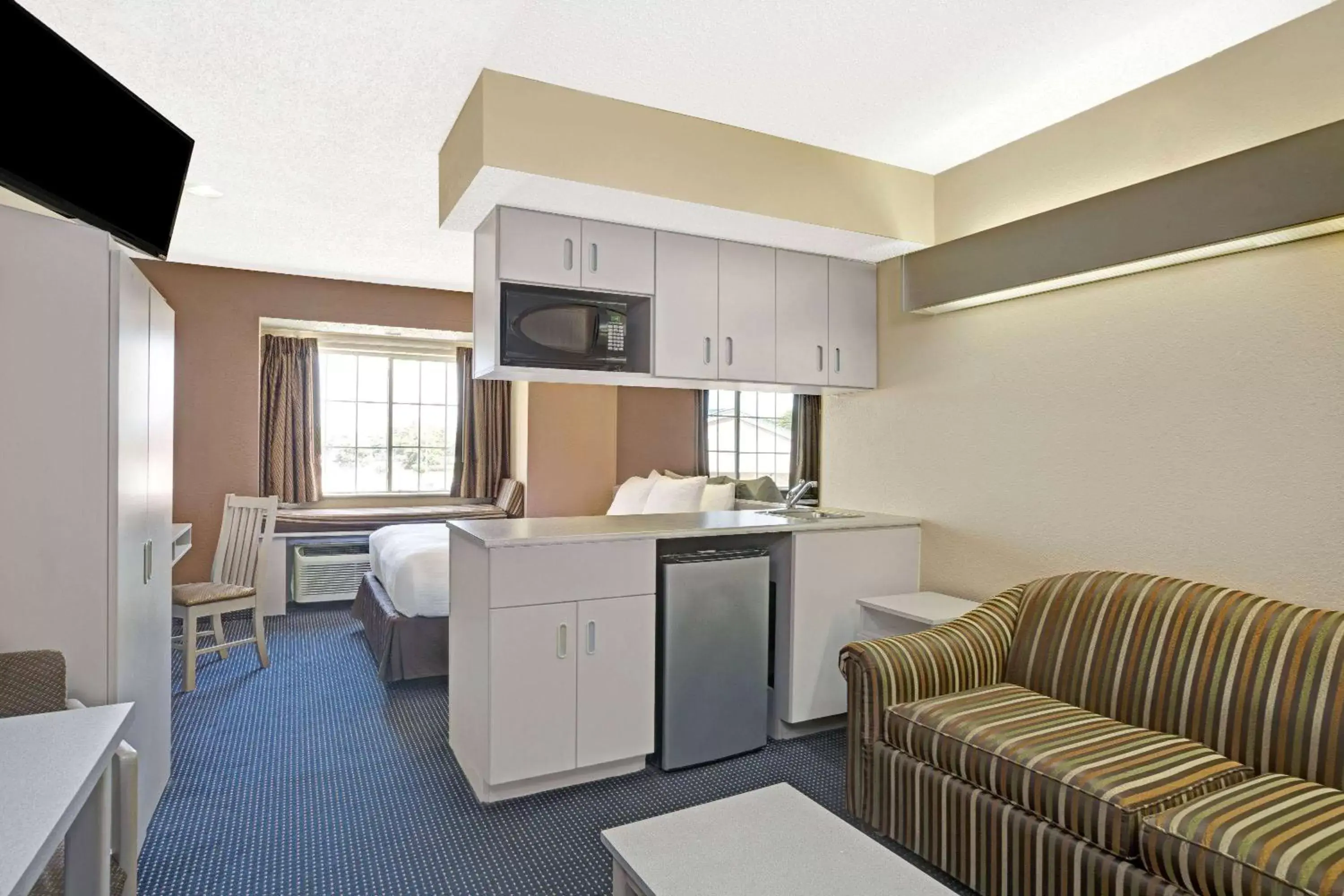 Bed, Kitchen/Kitchenette in Microtel Inn & Suites by Wyndham Houston/Webster/Nasa/Clearlake