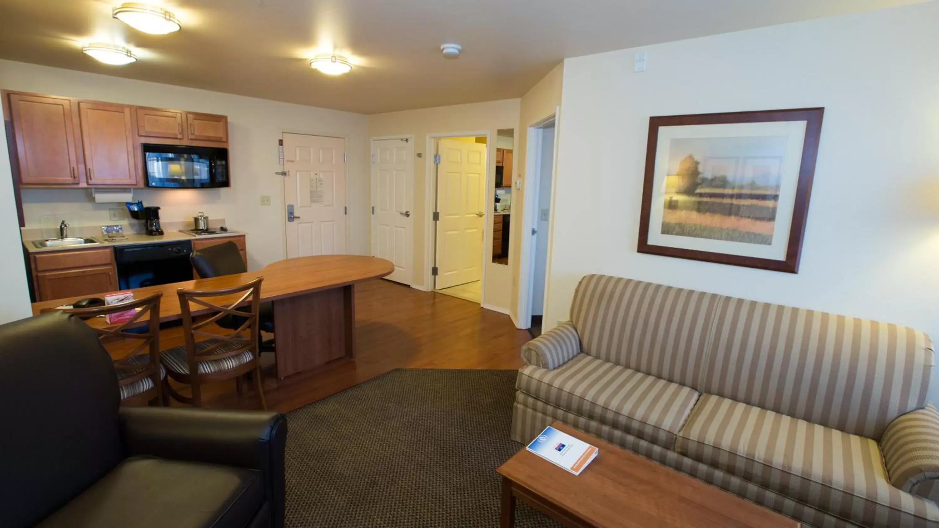 Bedroom, Seating Area in Candlewood Suites Joplin, an IHG Hotel