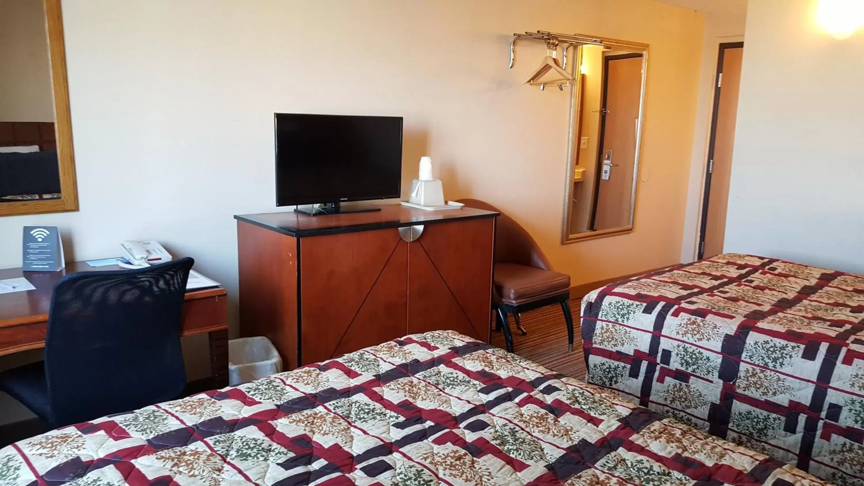 Bed, TV/Entertainment Center in Knights Inn and Suites - Grand Forks