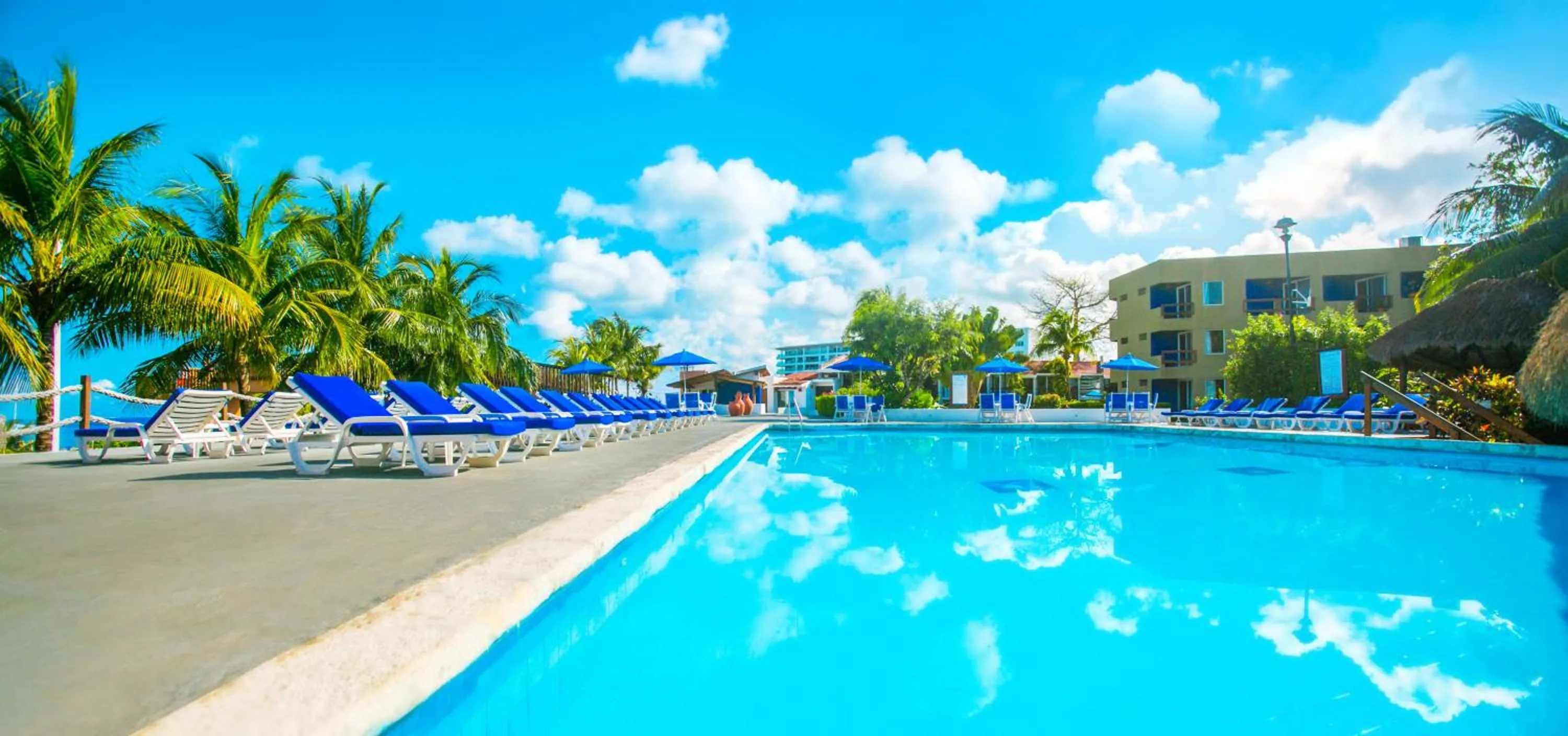Swimming pool in Casa del Mar Cozumel Hotel & Dive Resort with free access to an exclusive beach club