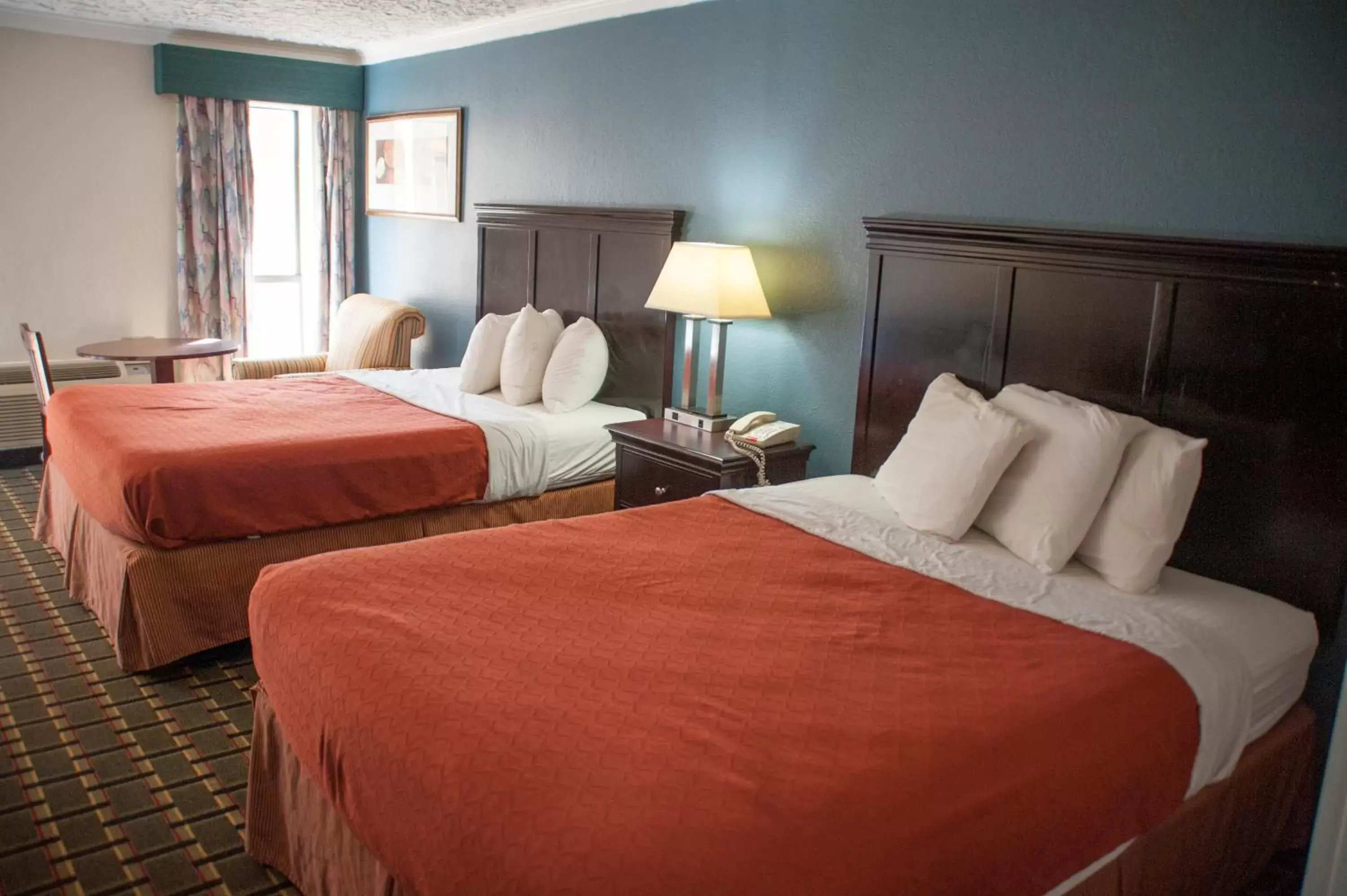 Bed in Victorian Inn & Suites