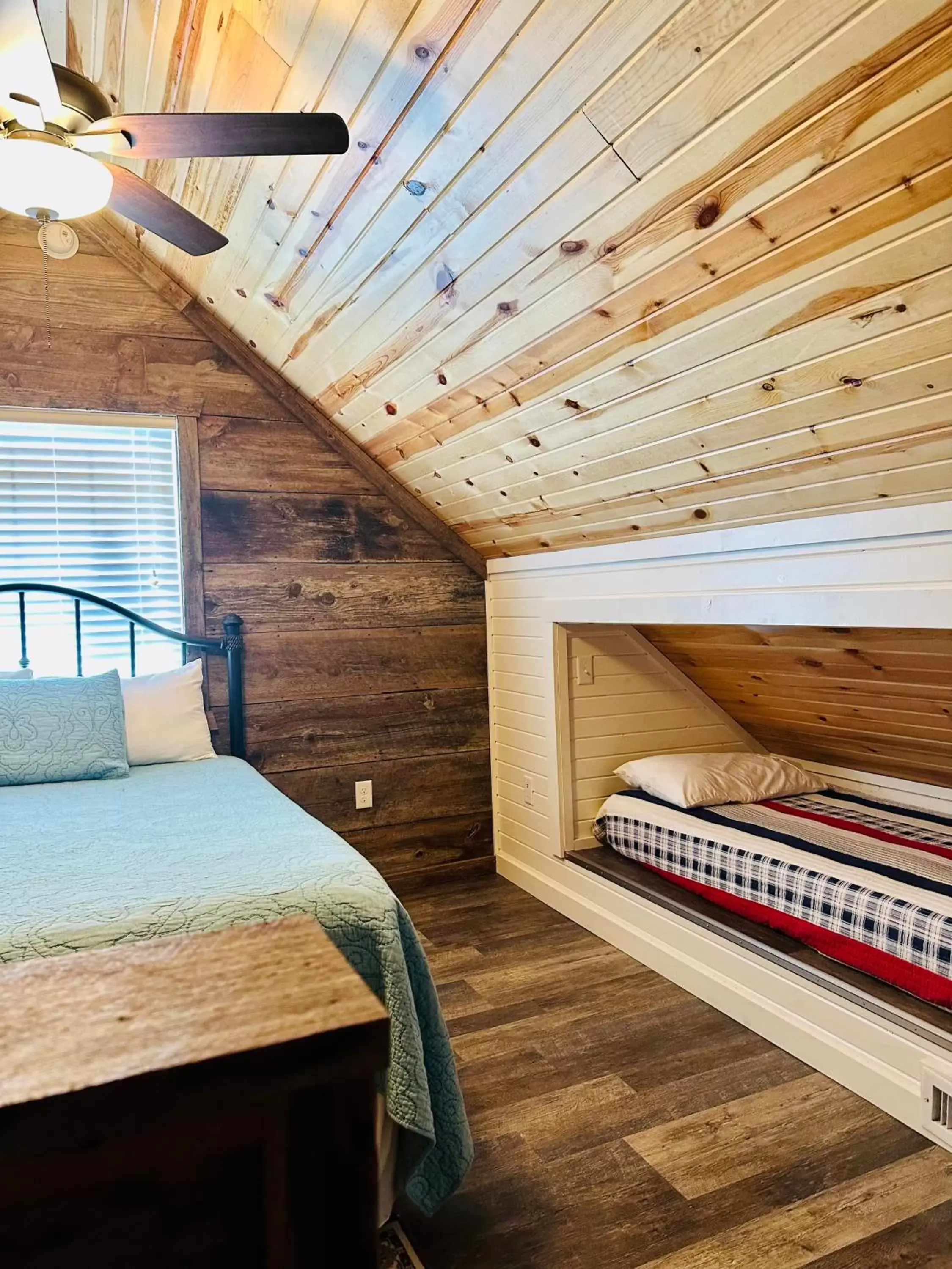 Bed in Knotty Squirrel Cabins