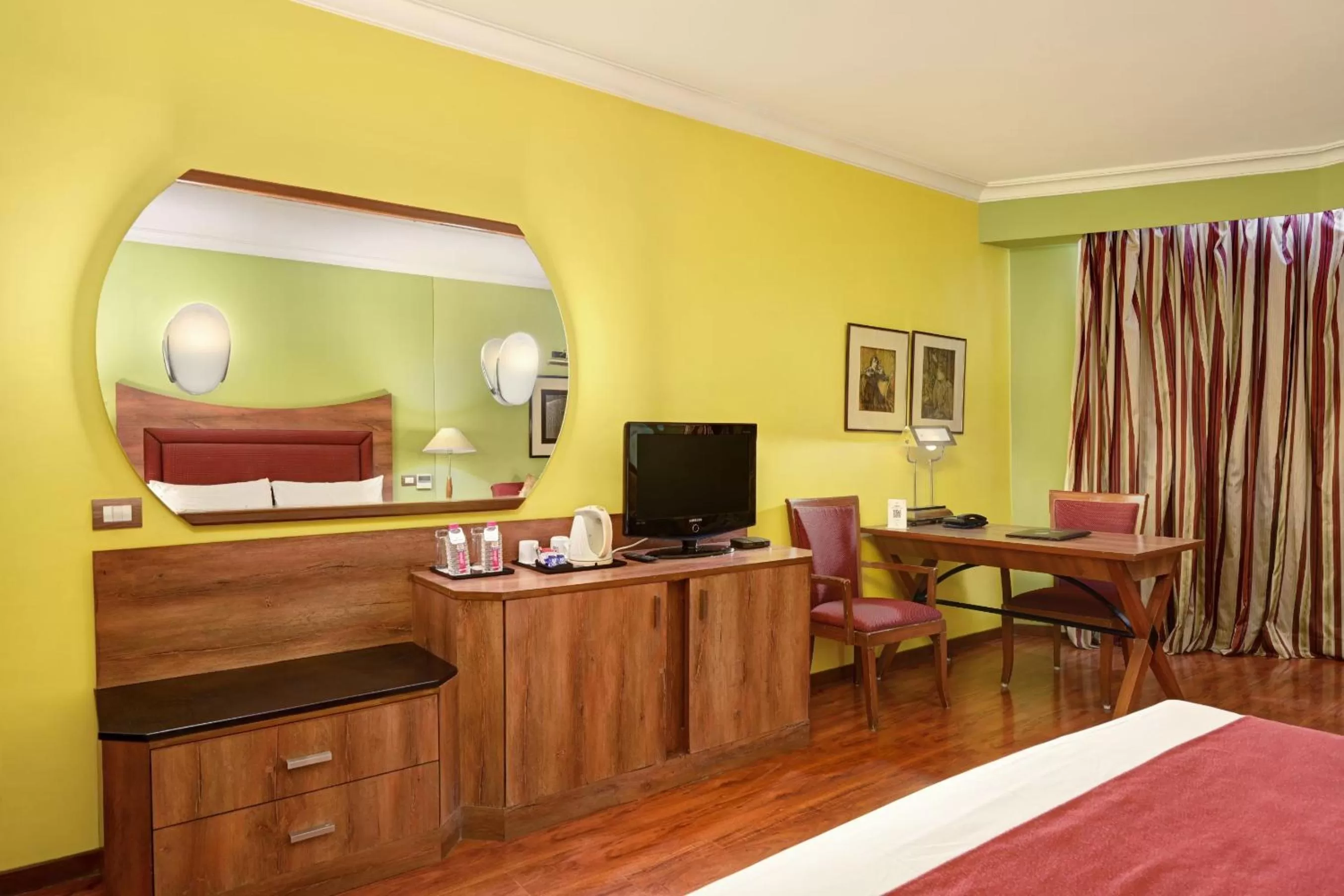 Communal lounge/ TV room, Bed in The Cama - A Sabarmati Riverfront Hotel