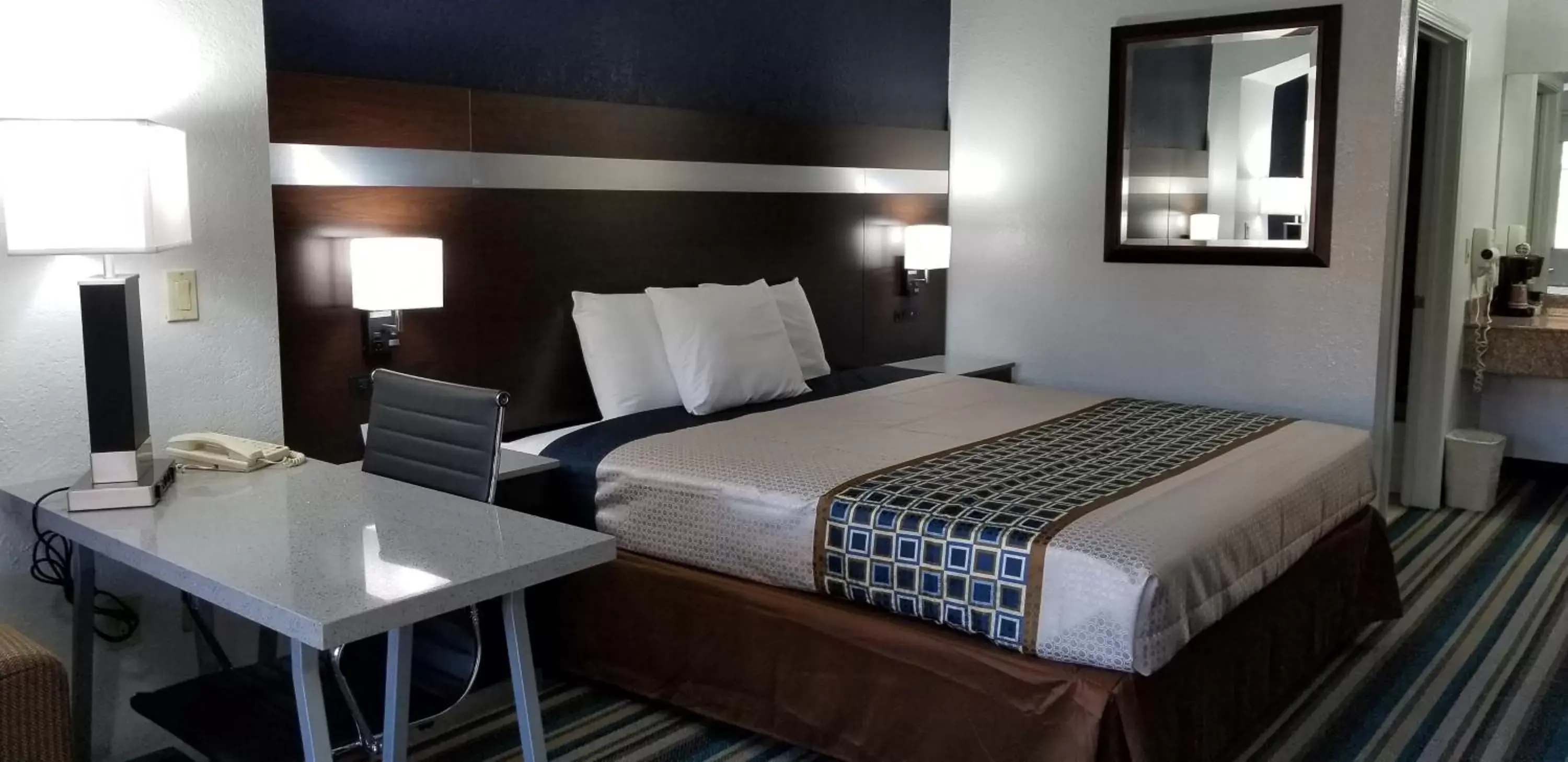 Bed in HomeBridge Inn and Suites