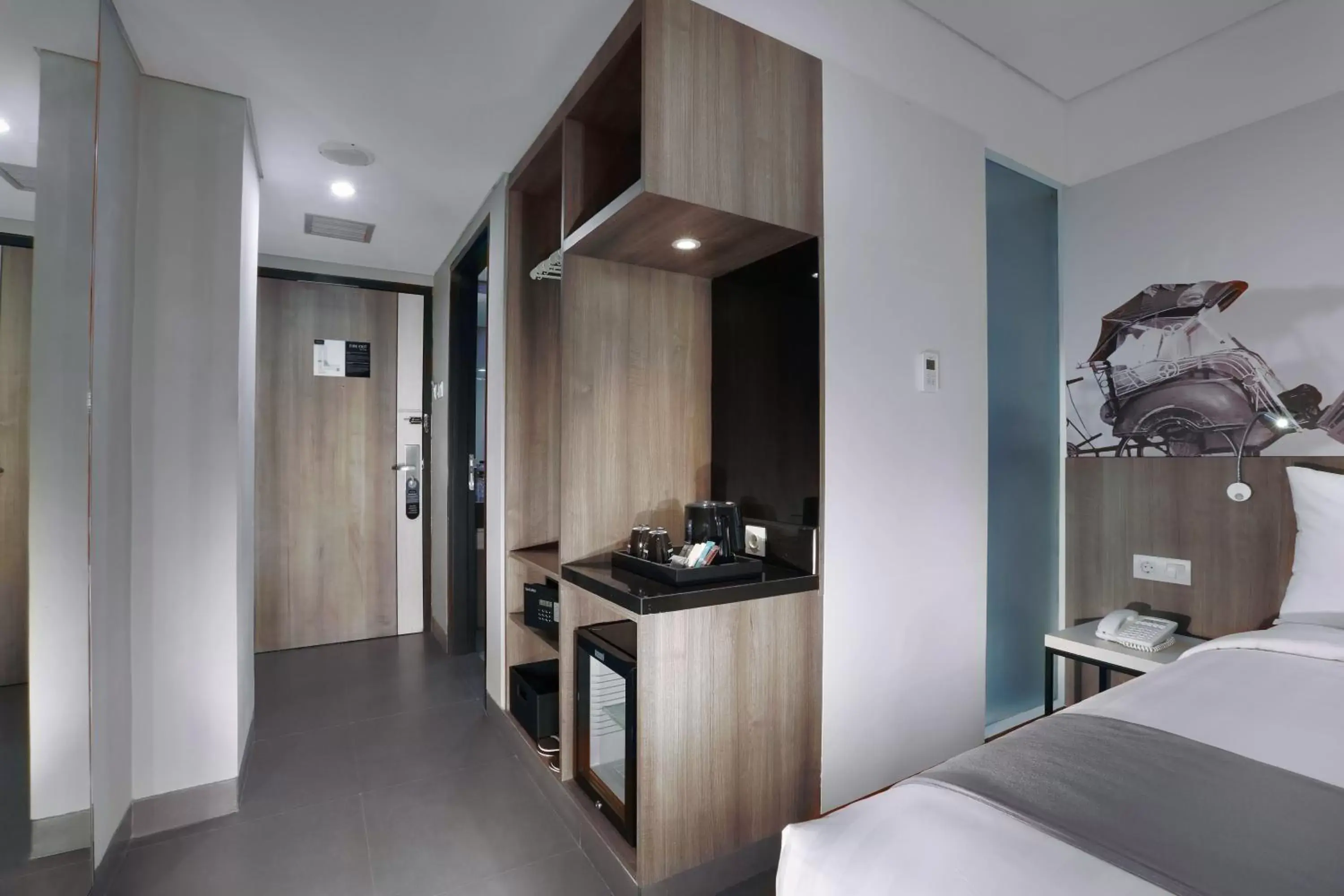 Bedroom, Kitchen/Kitchenette in Hotel Neo Malioboro by ASTON