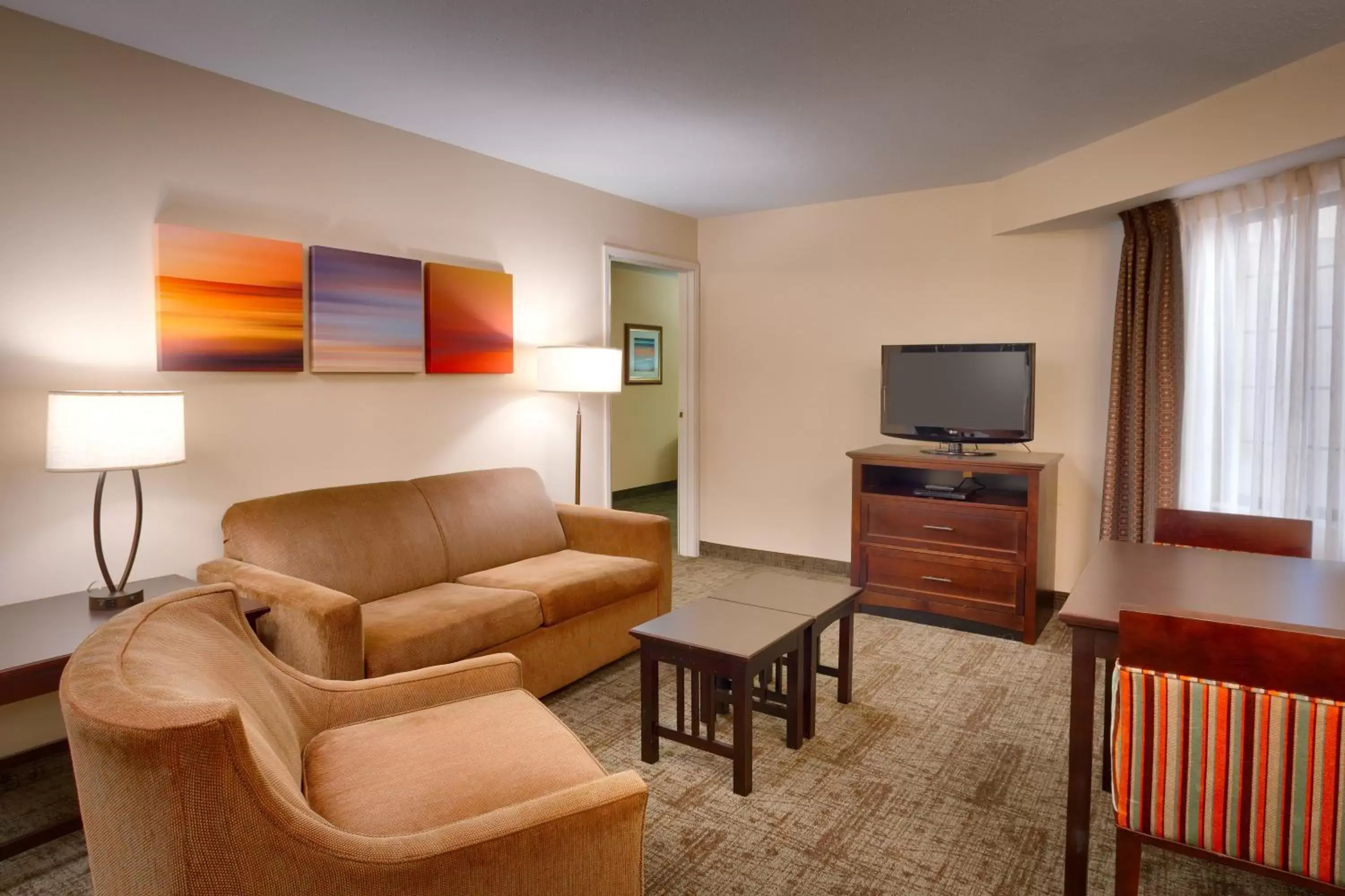 Bedroom, Seating Area in Staybridge Suites Peoria Downtown, an IHG Hotel