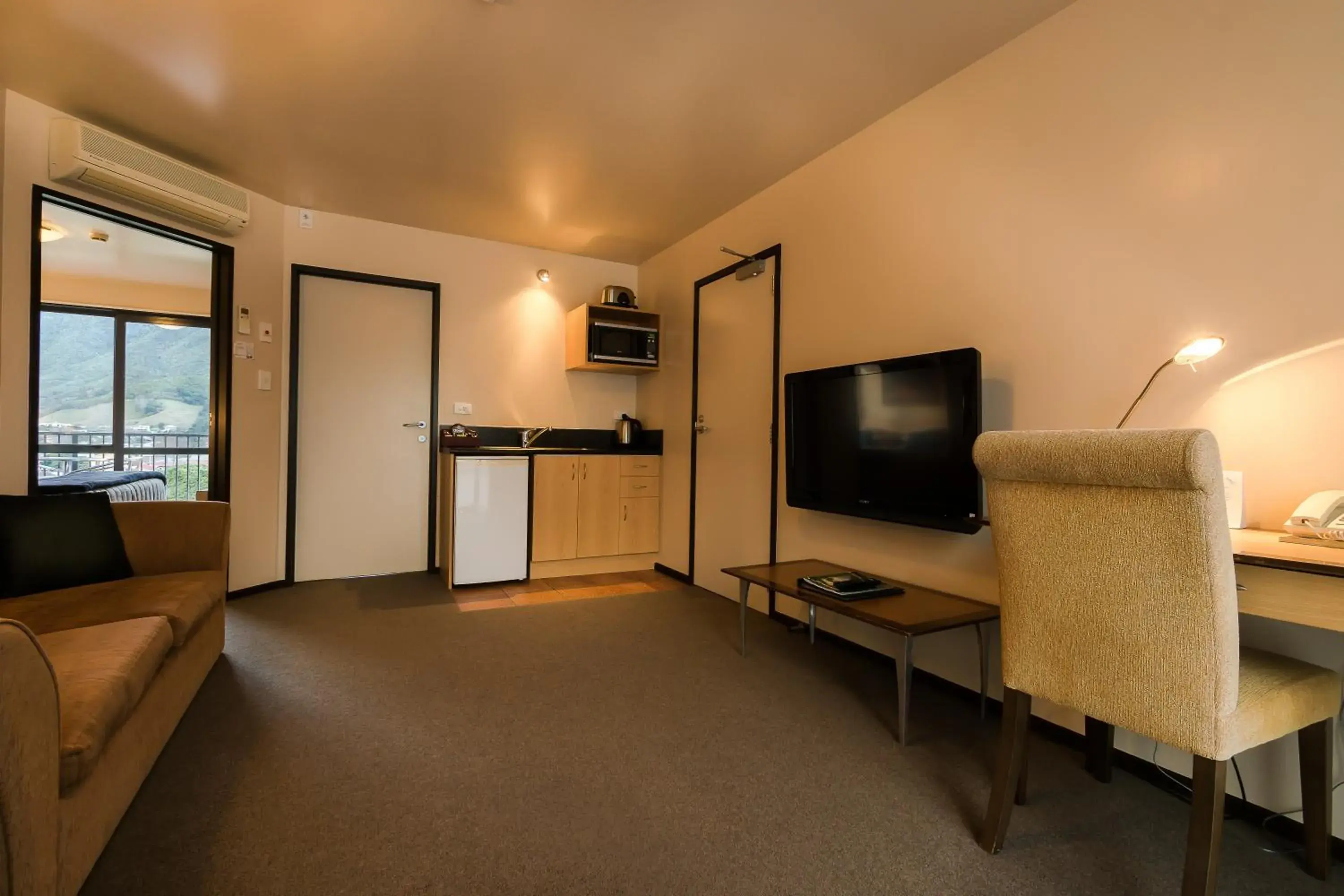 Photo of the whole room, TV/Entertainment Center in Broadway Motel