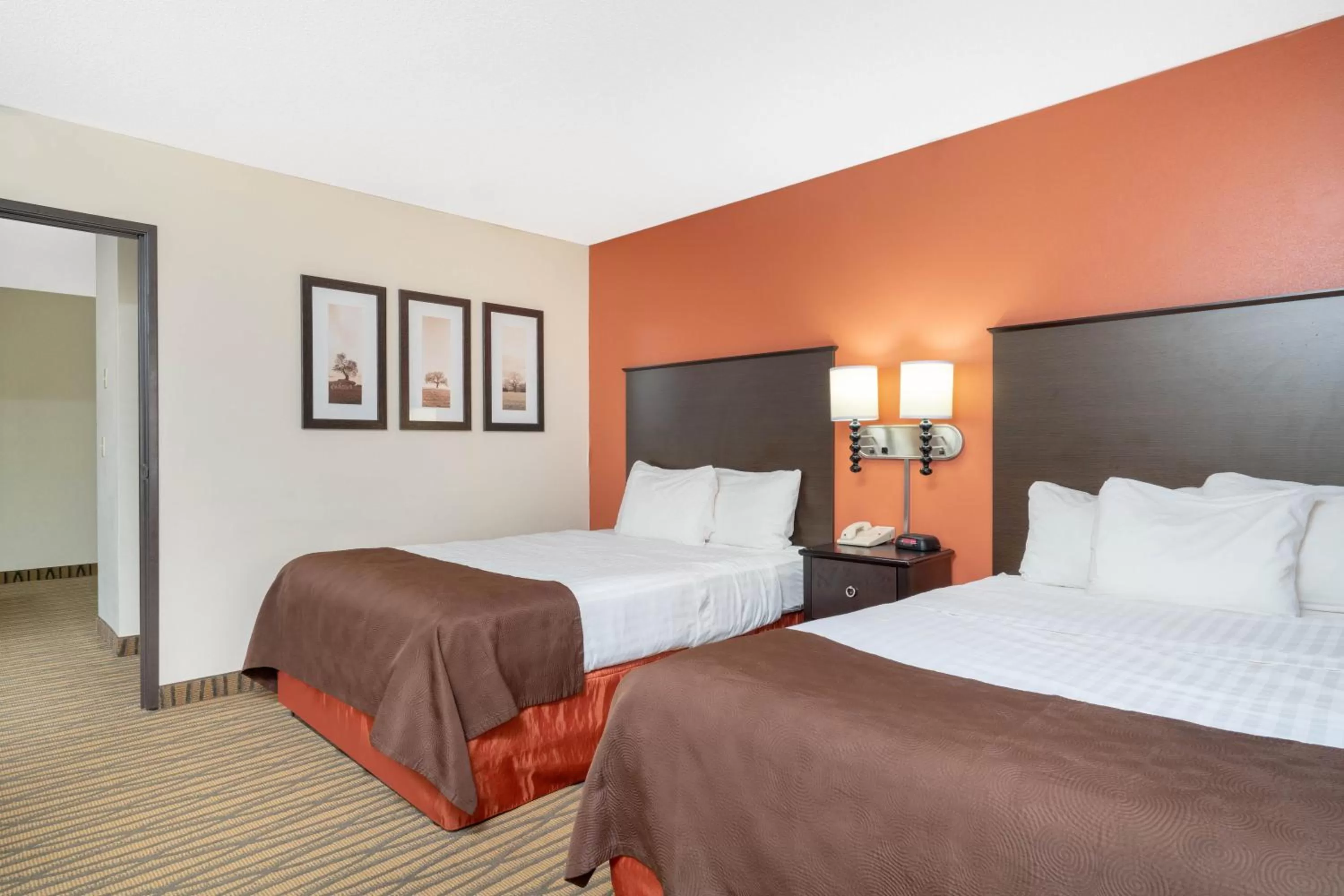 Bed in AmericInn by Wyndham Rogers