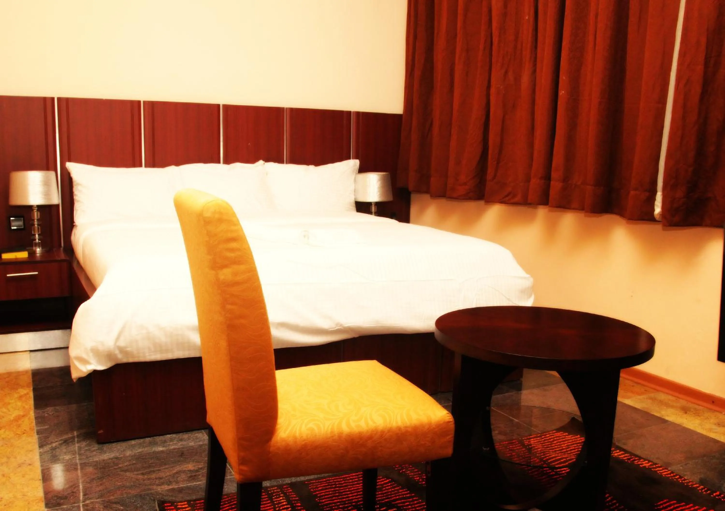 Seating area, Bed in Swiss International Mabisel Port Harcourt