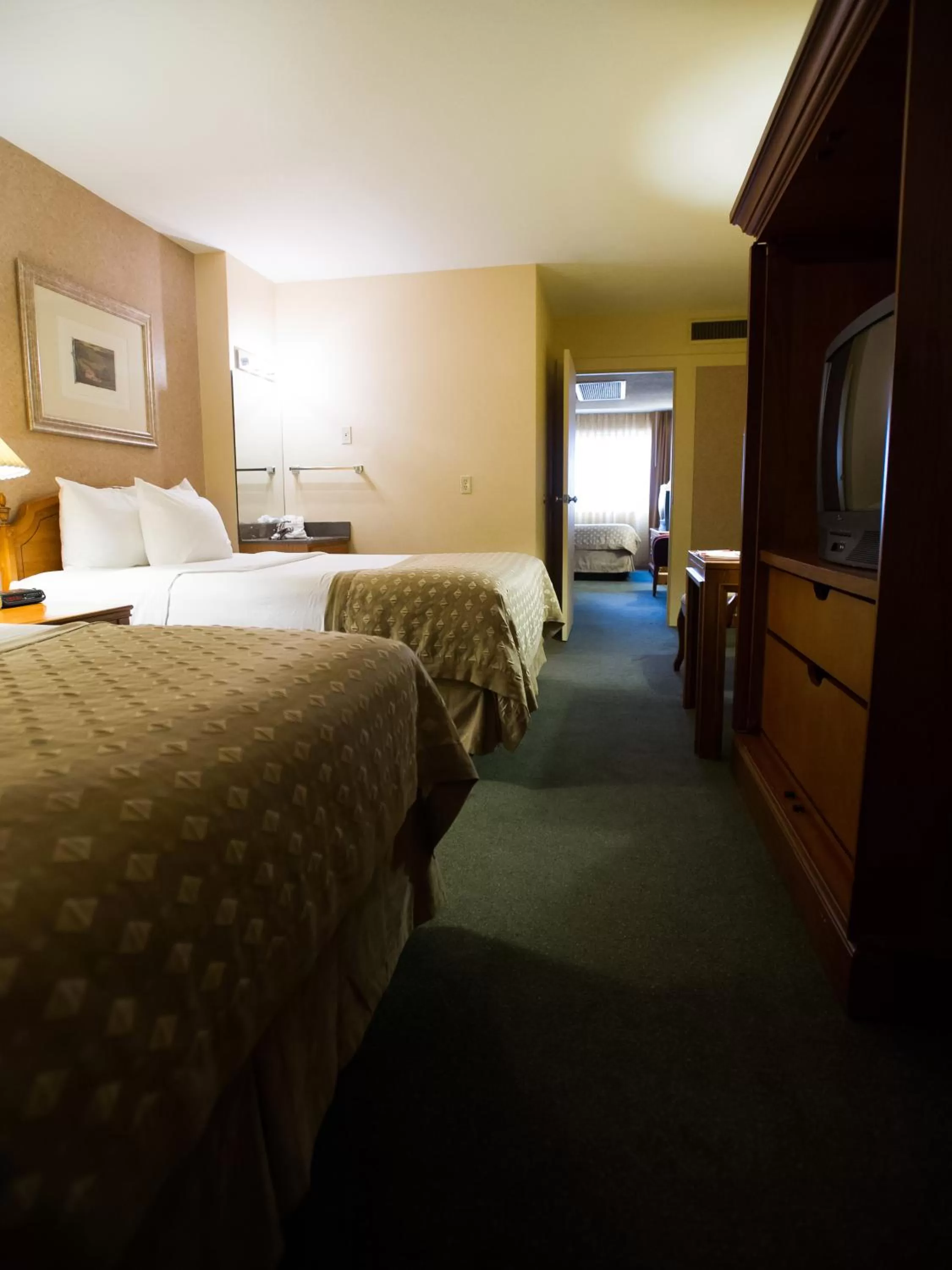 Deluxe Queen Room with Three Queen Beds Non Smoking in Ramada by Wyndham Topeka Downtown Hotel & Convention Center