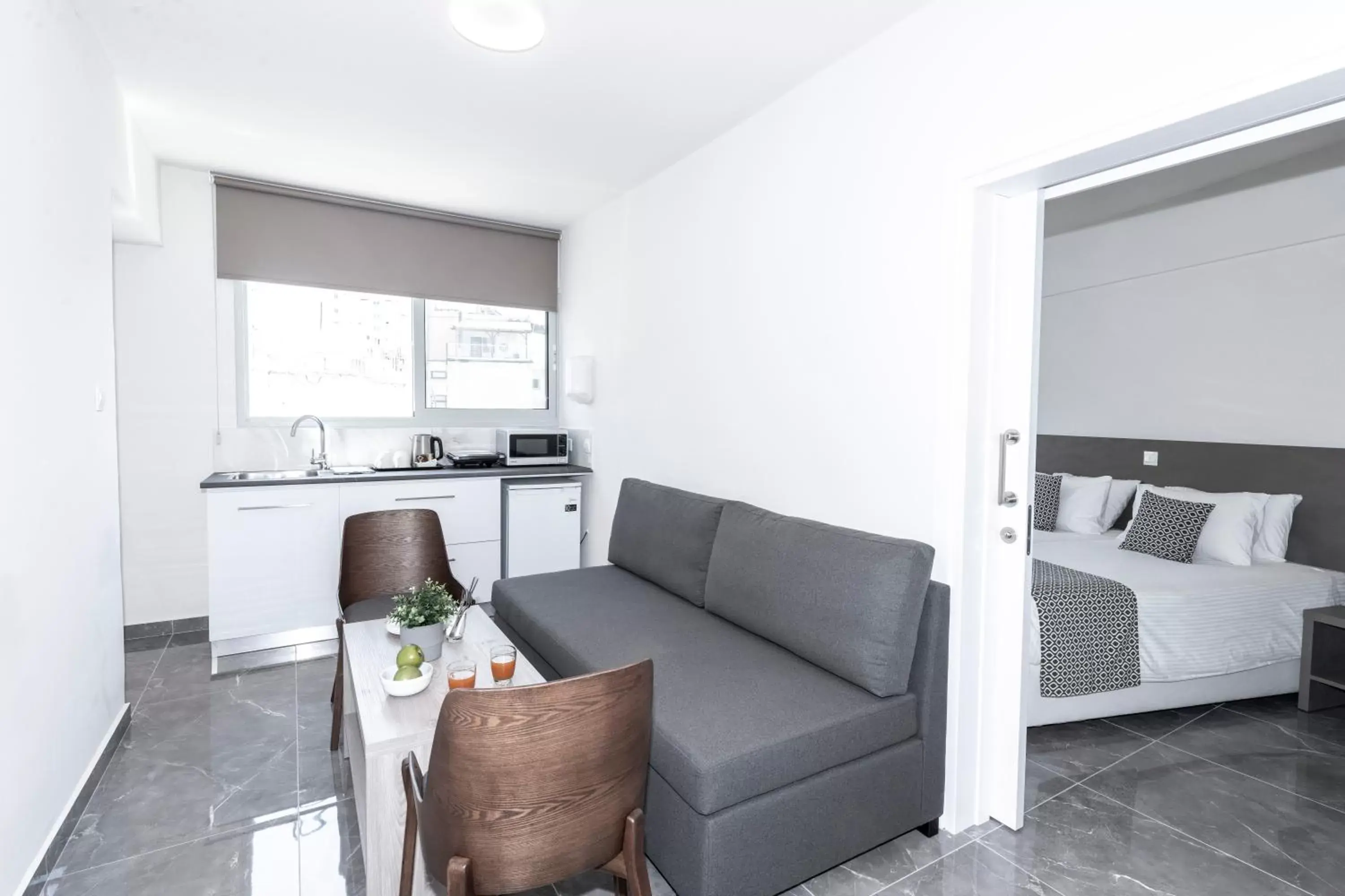 Bed, Seating Area in Blazer Residence