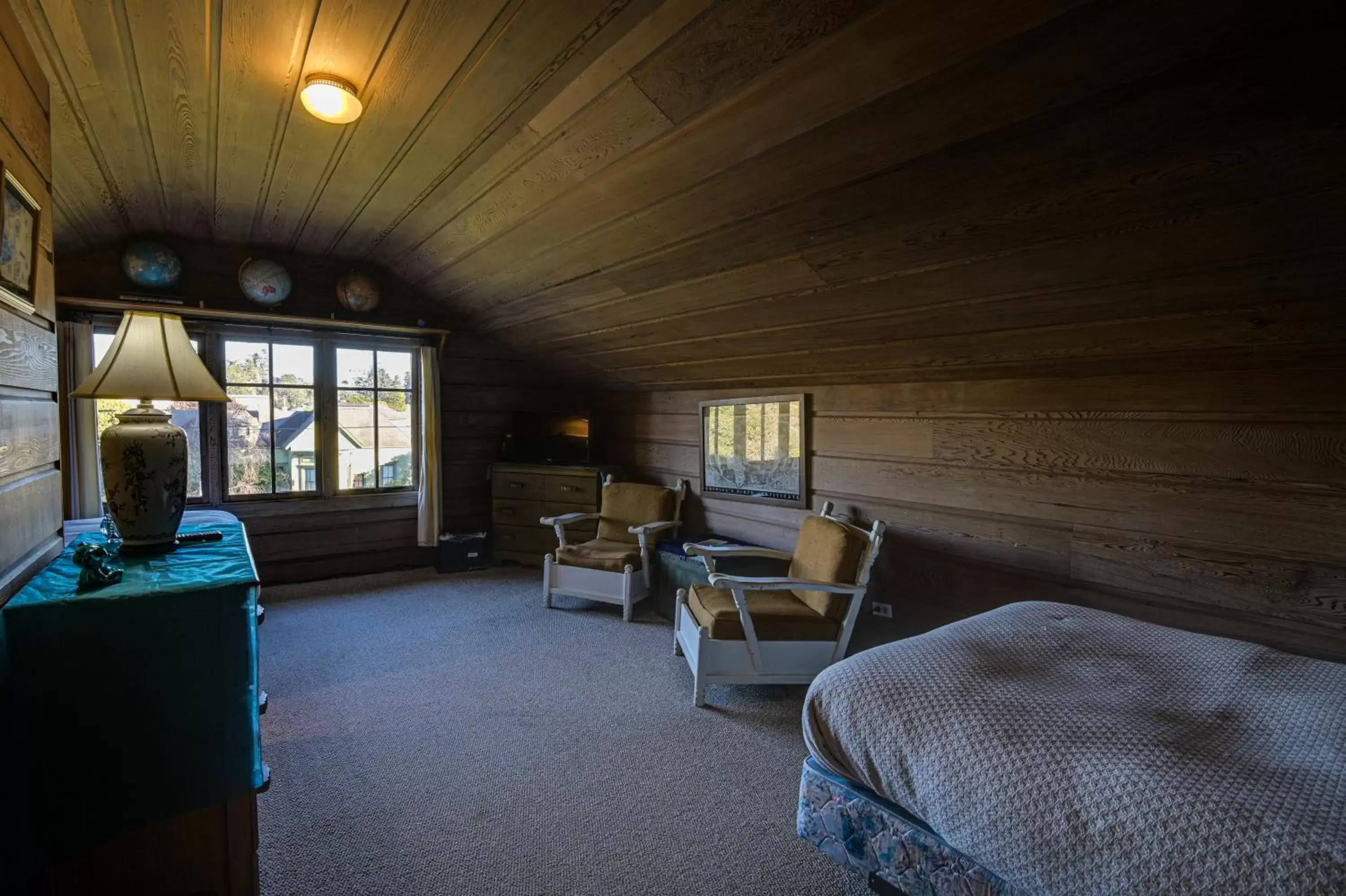 Bed, Seating Area in The Captains Quarters