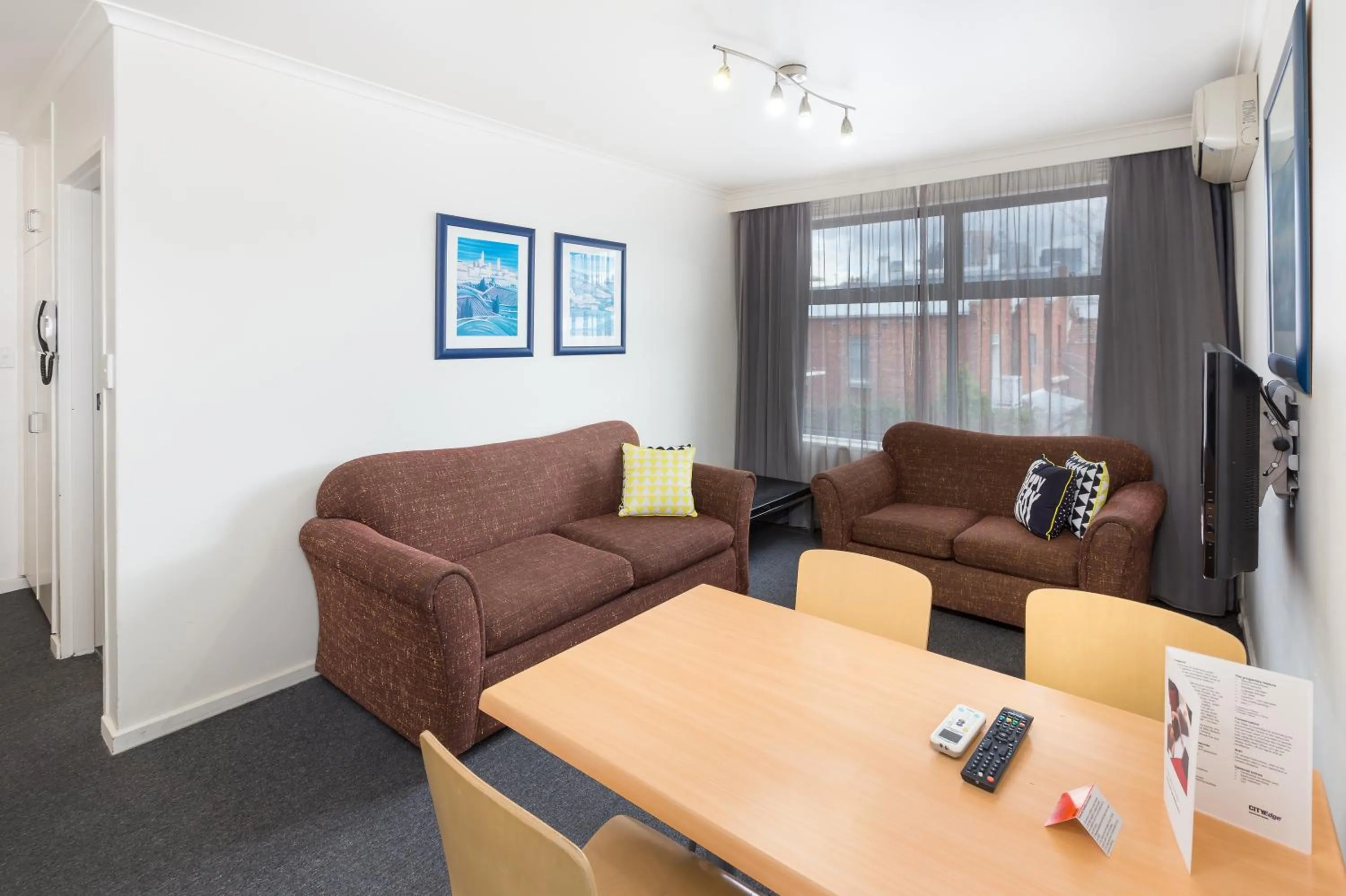 Living room in City Edge East Melbourne Apartment Hotel