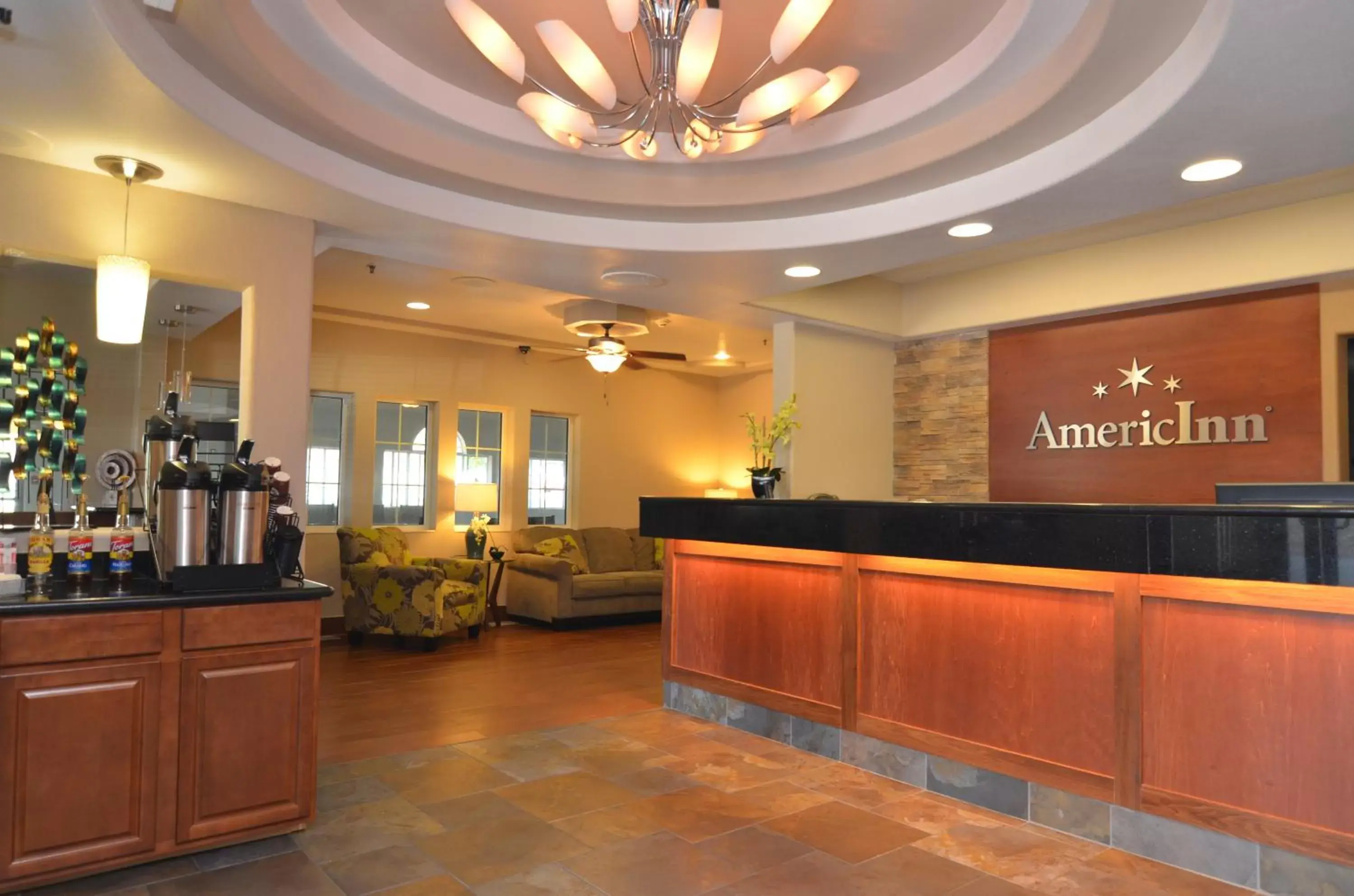 Communal lounge/ TV room, Lobby/Reception in AmericInn by Wyndham Des Moines Airport