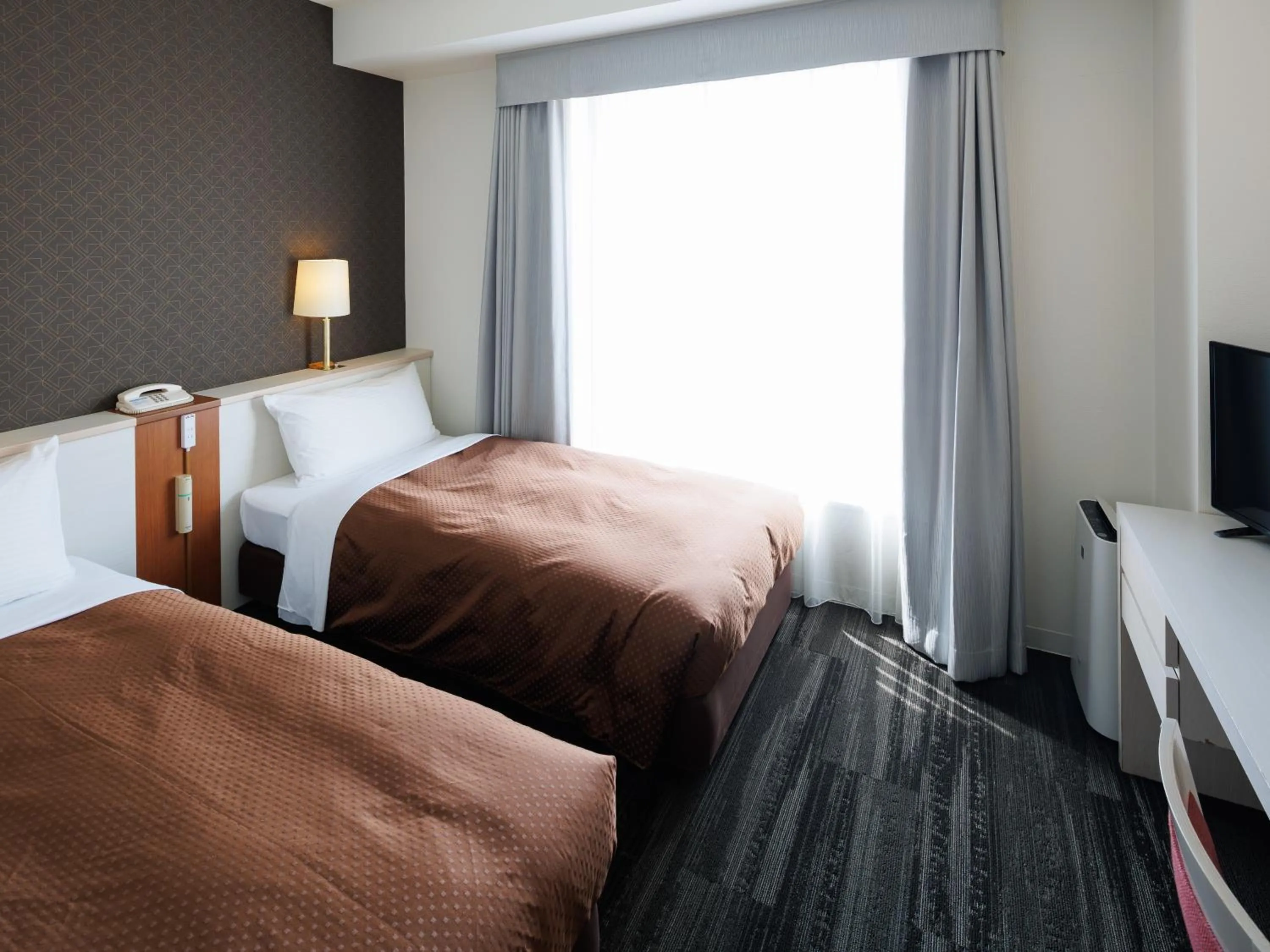 Bed in J Hotel Rinku