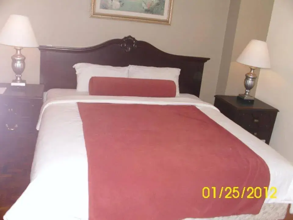 Bed in Lourdes Suites