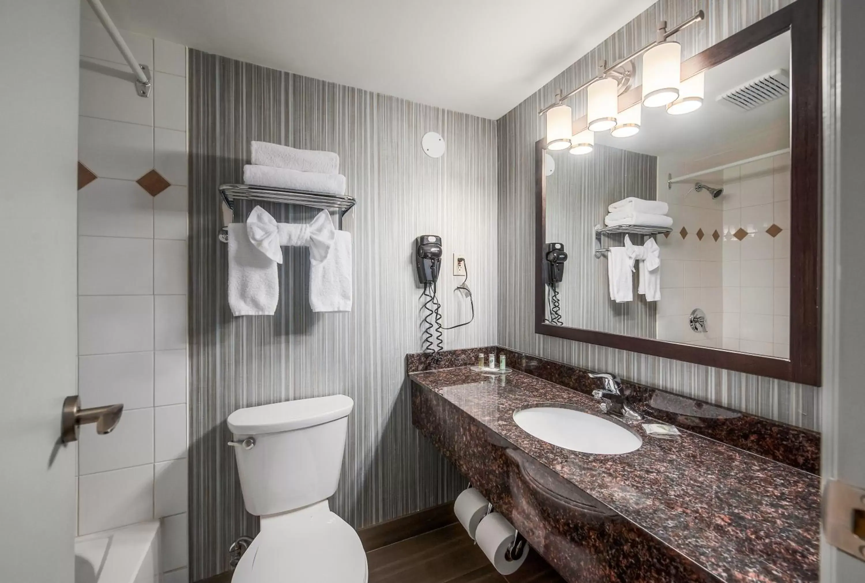 Bathroom in Coast Calgary Downtown Hotel & Suites by APA