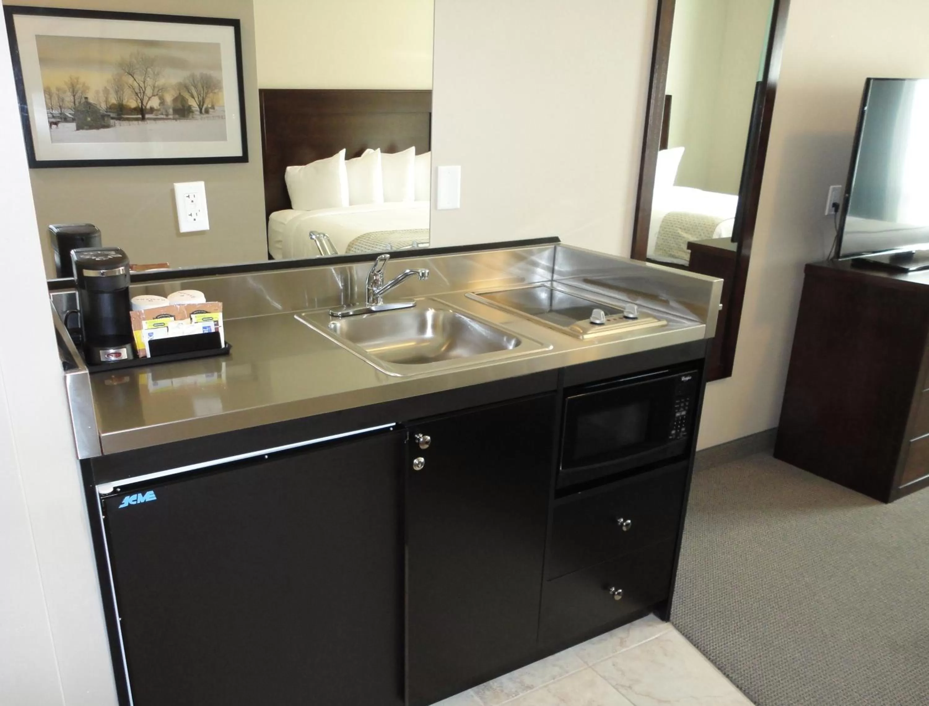 Living room in Ramada by Wyndham Emerald Park/Regina East