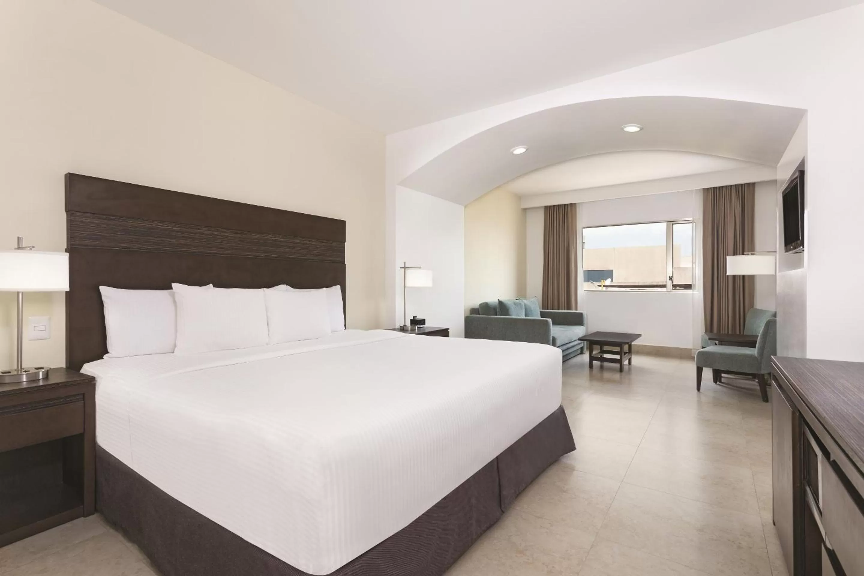 Seating area, Bed in Wyndham Garden Cancun Downtown