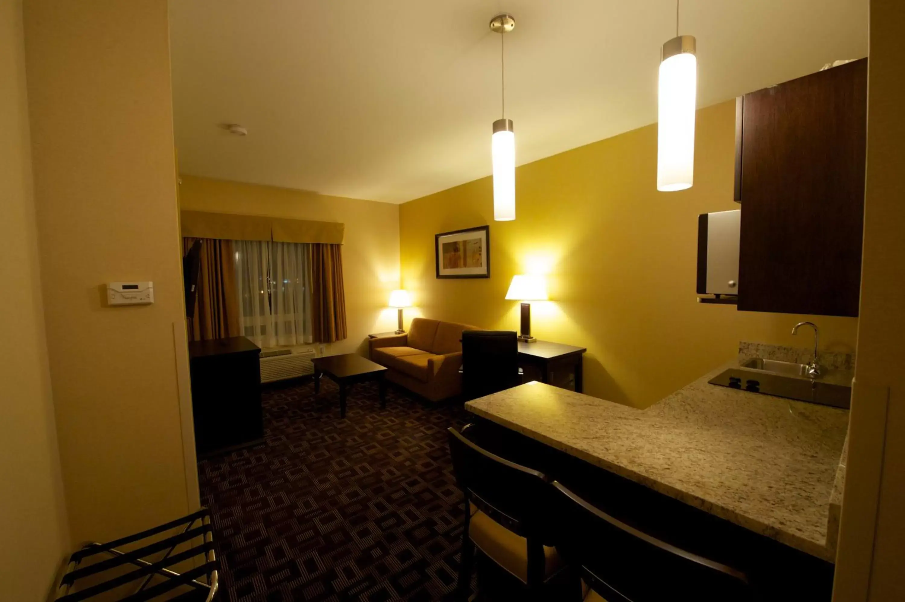 Photo of the whole room, TV/Entertainment Center in Days Inn & Suites by Wyndham Winnipeg Airport Manitoba
