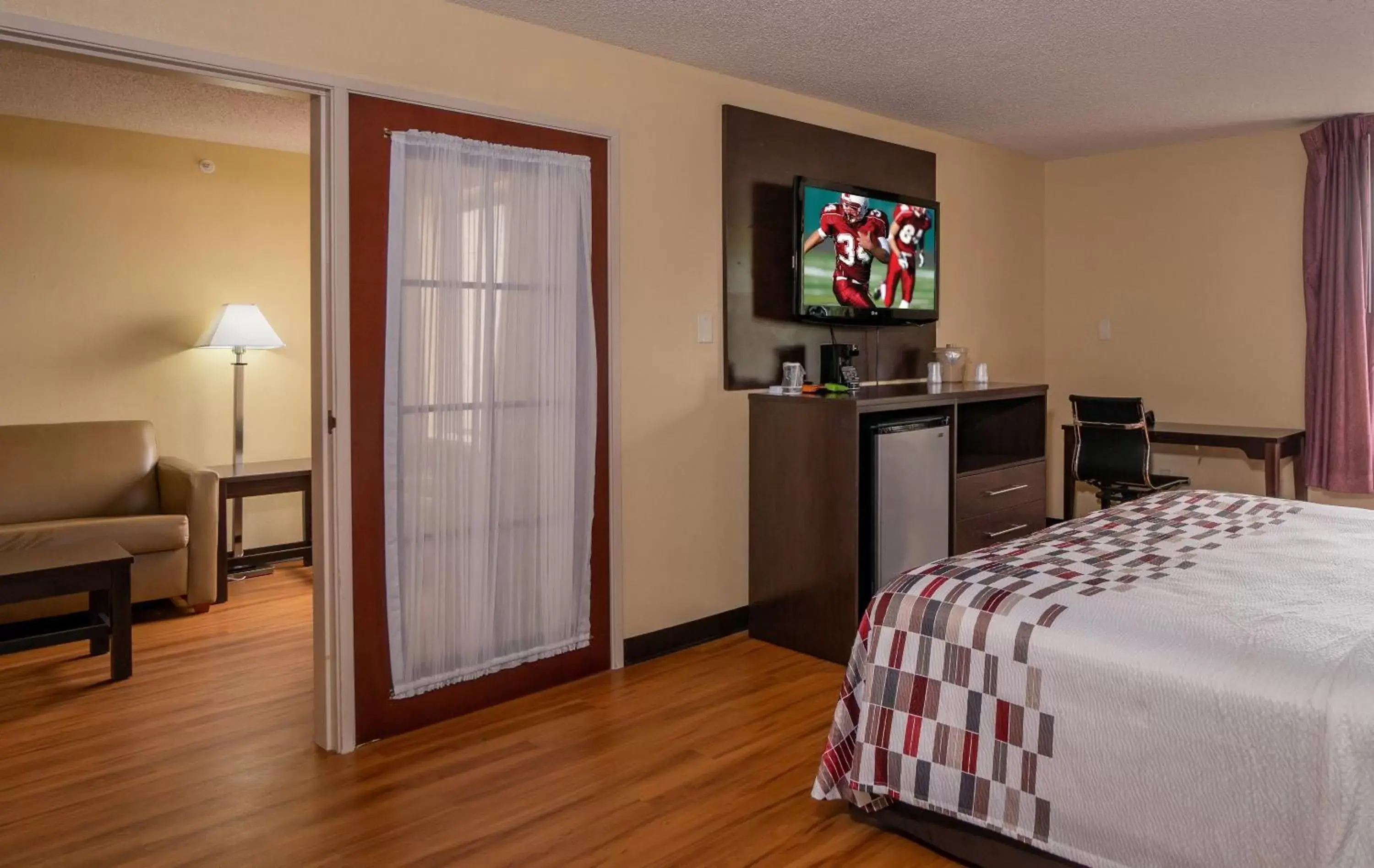 Photo of the whole room, TV/Entertainment Center in Red Roof Inn & Suites Indianapolis Airport