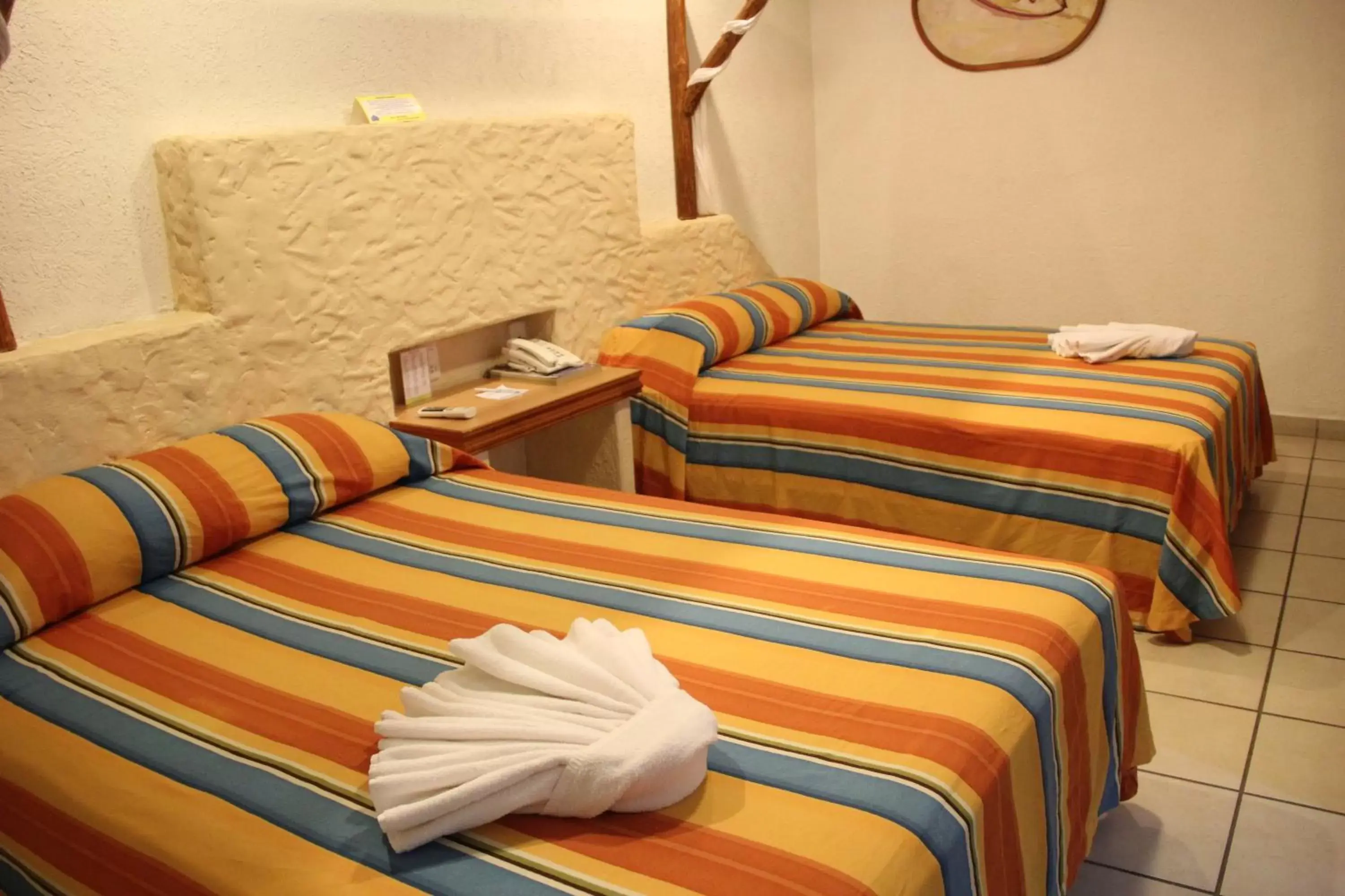 Bed in Hotel Palapa Palace Inn