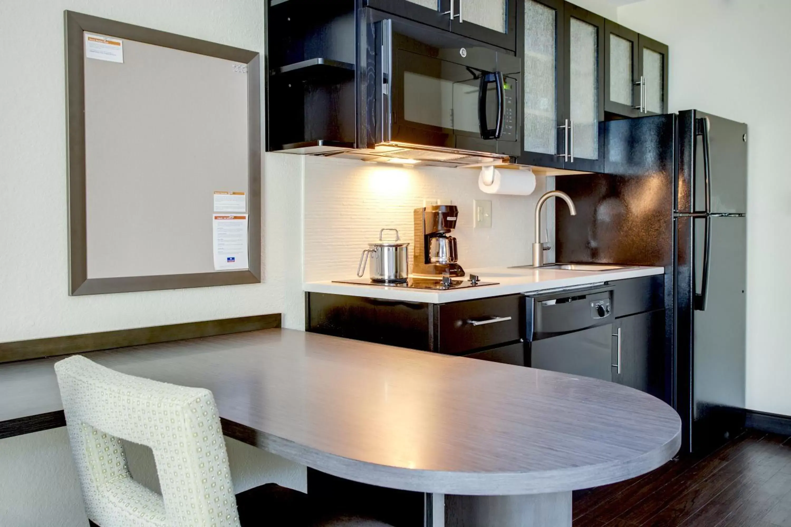 Photo of the whole room, Kitchen/Kitchenette in Candlewood Suites Raleigh Crabtree, an IHG Hotel