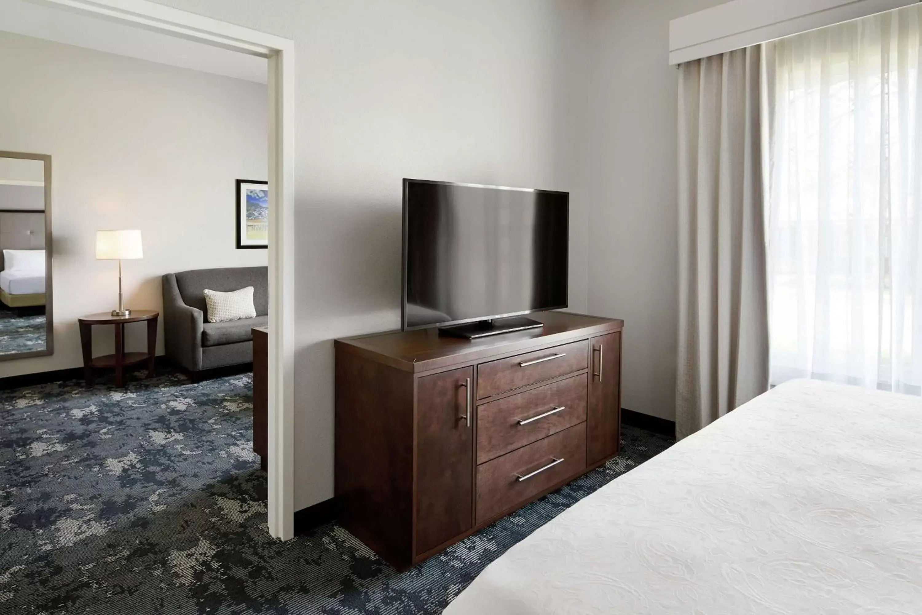 Bedroom, TV/Entertainment Center in Homewood Suites Champaign-Urbana