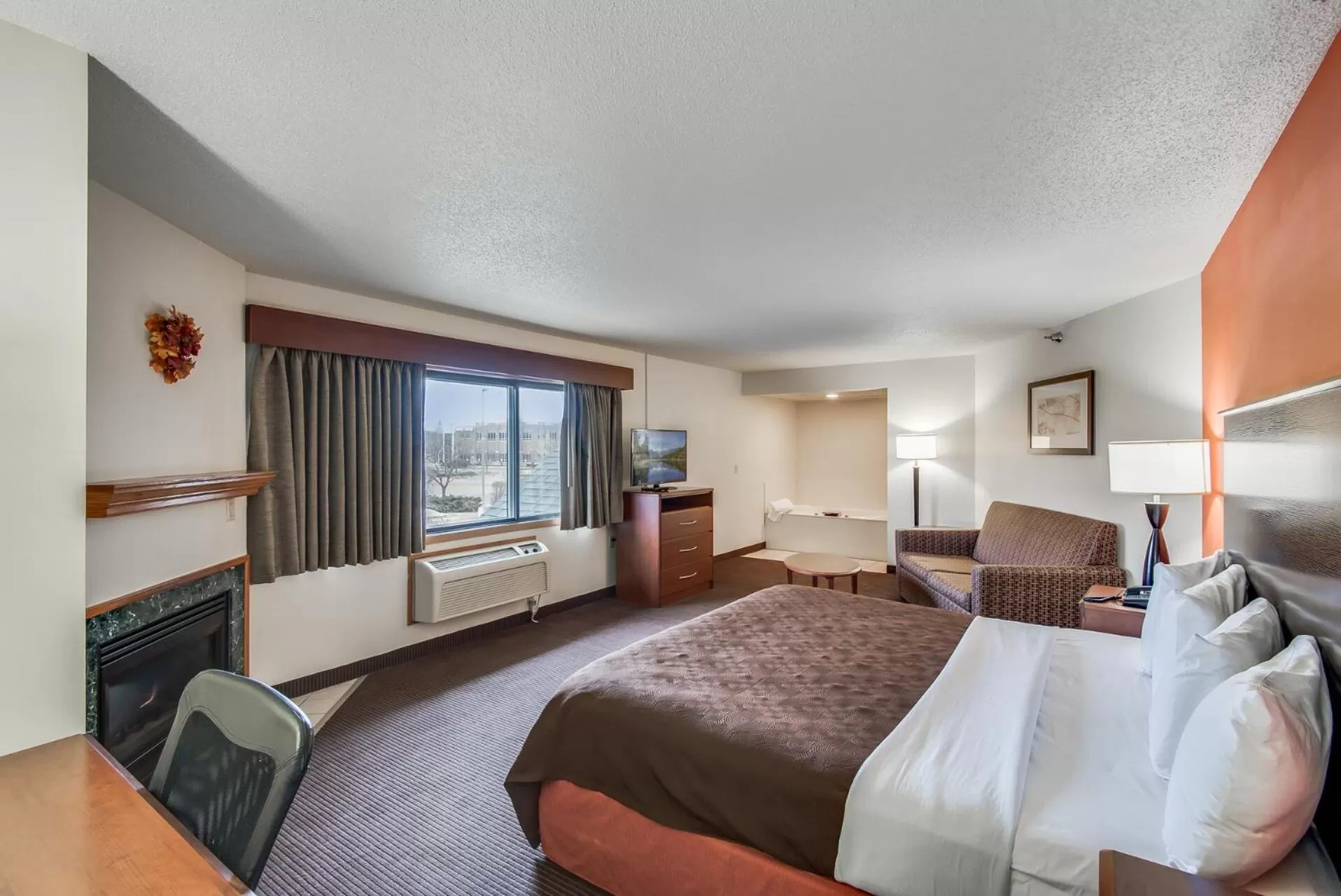 Bed in AmericInn by Wyndham Coon Rapids