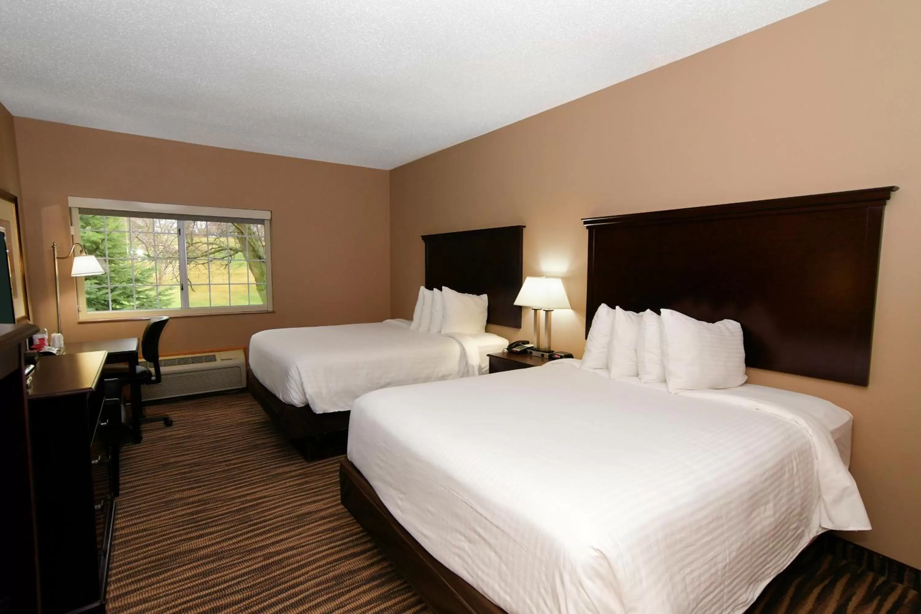 Bed in Cobblestone Inn & Suites - Denison | Majestic Hills