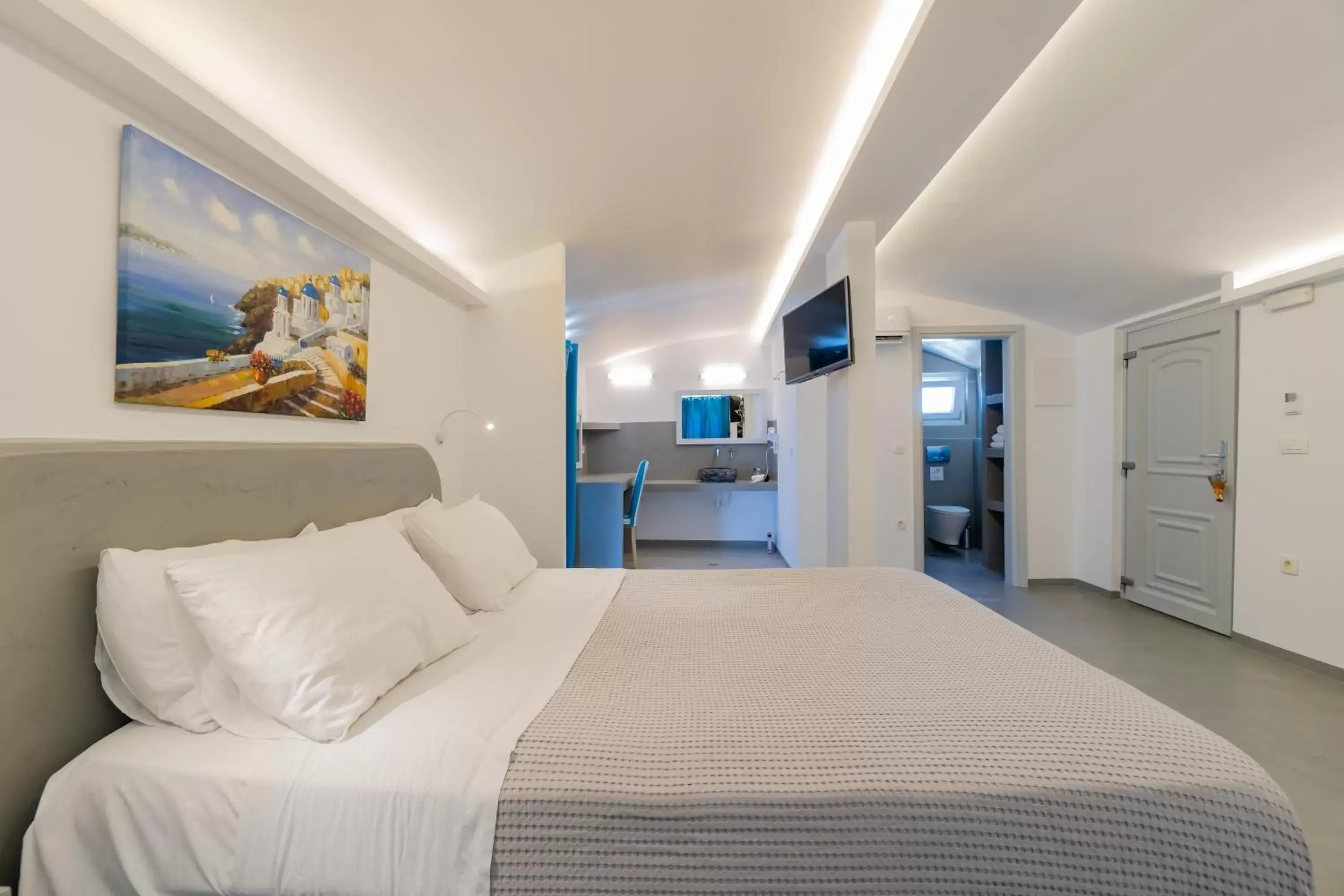 Bed in Central Fira Suites