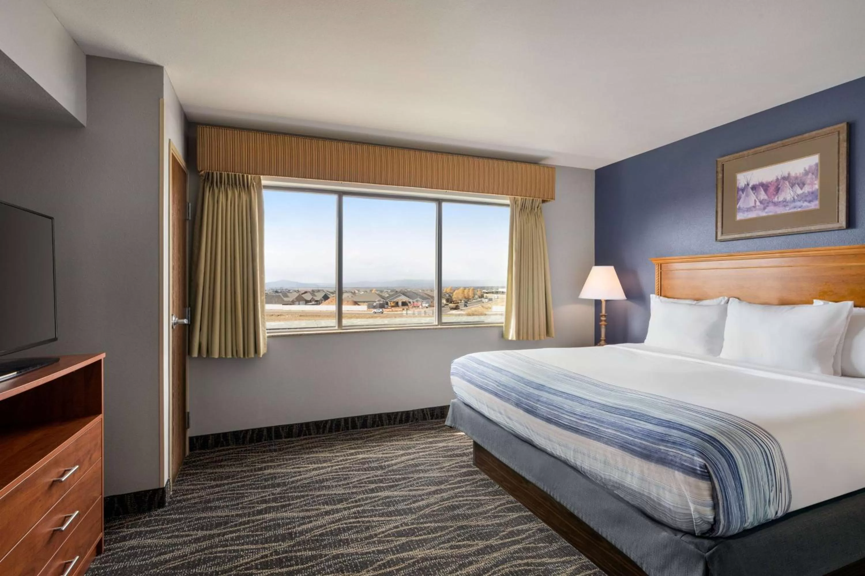 Bed in AmericInn by Wyndham Laramie Near University of Wyoming