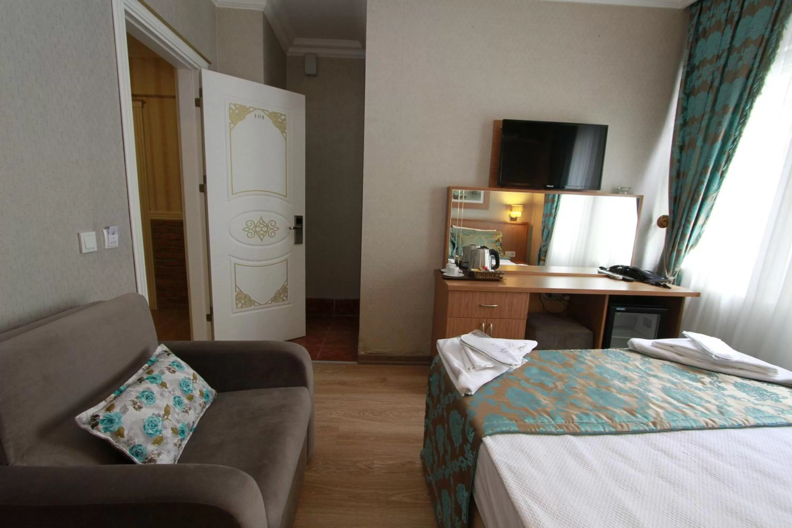 Communal lounge/ TV room, Bed in Agora Boutique Hotel & Bistro