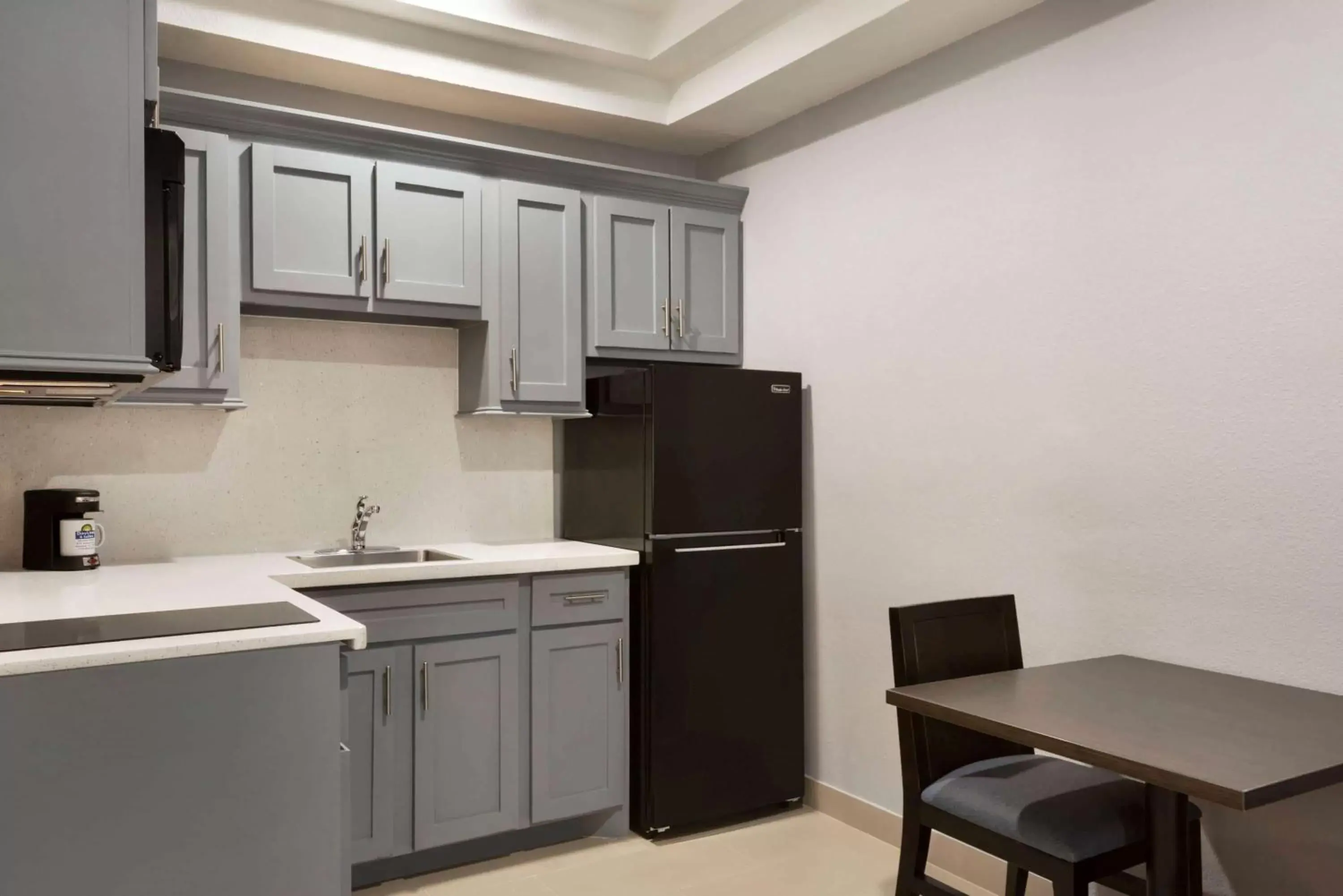 Photo of the whole room, Kitchen/Kitchenette in Days Inn & Suites by Wyndham Houston Hobby Airport