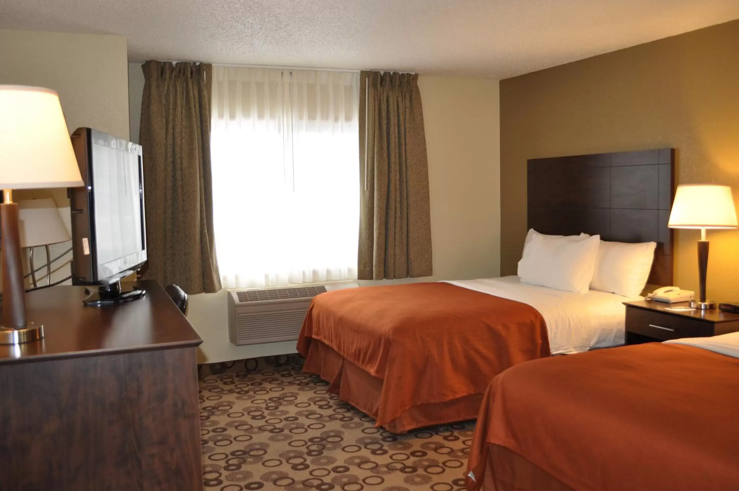 Bed in AmericInn by Wyndham Cedar Falls