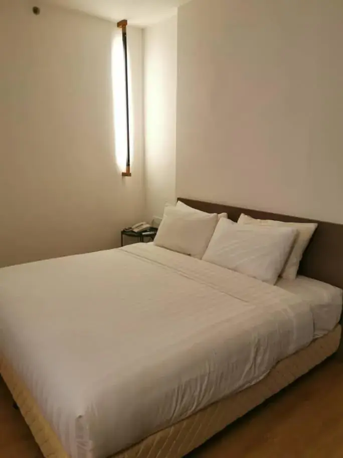 Bed in T+ PREMIUM HOTEL