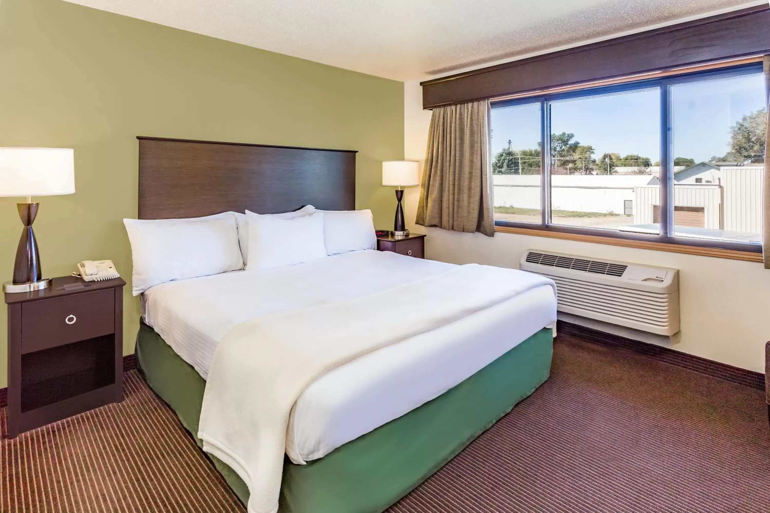 Bed in AmericInn by Wyndham Hampton